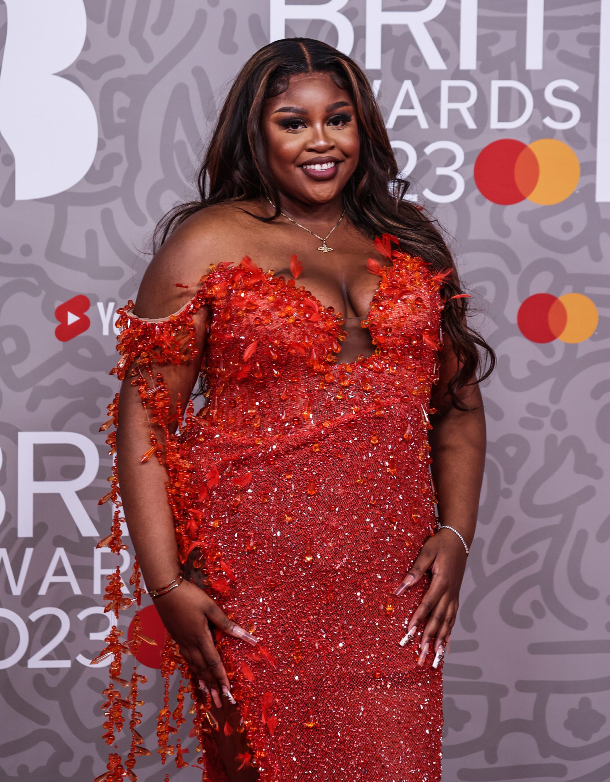 Nella Rose smiling on the BRITs red carpet