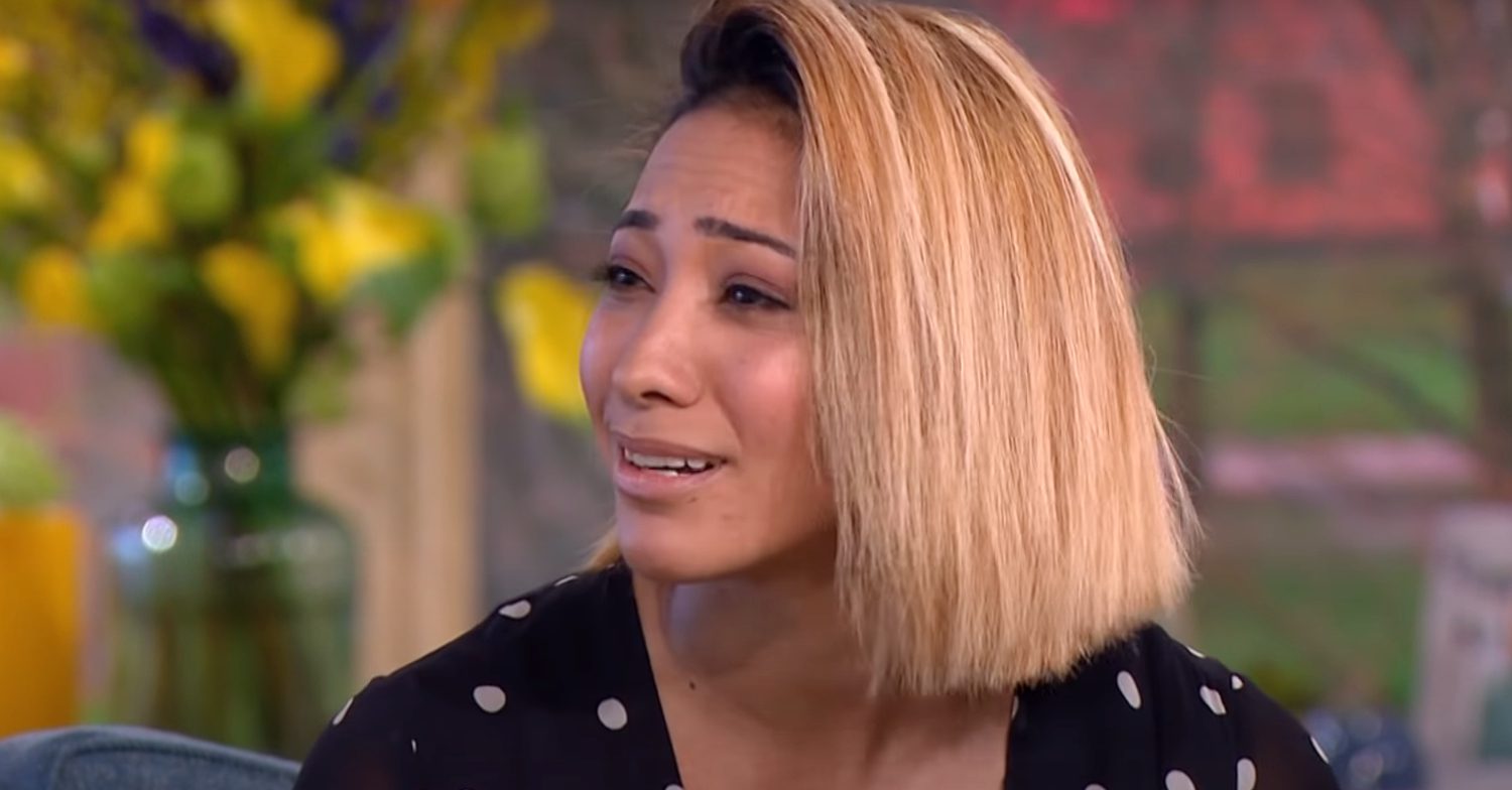 Karen Clifton with a blonde bob looking pained during an interview
