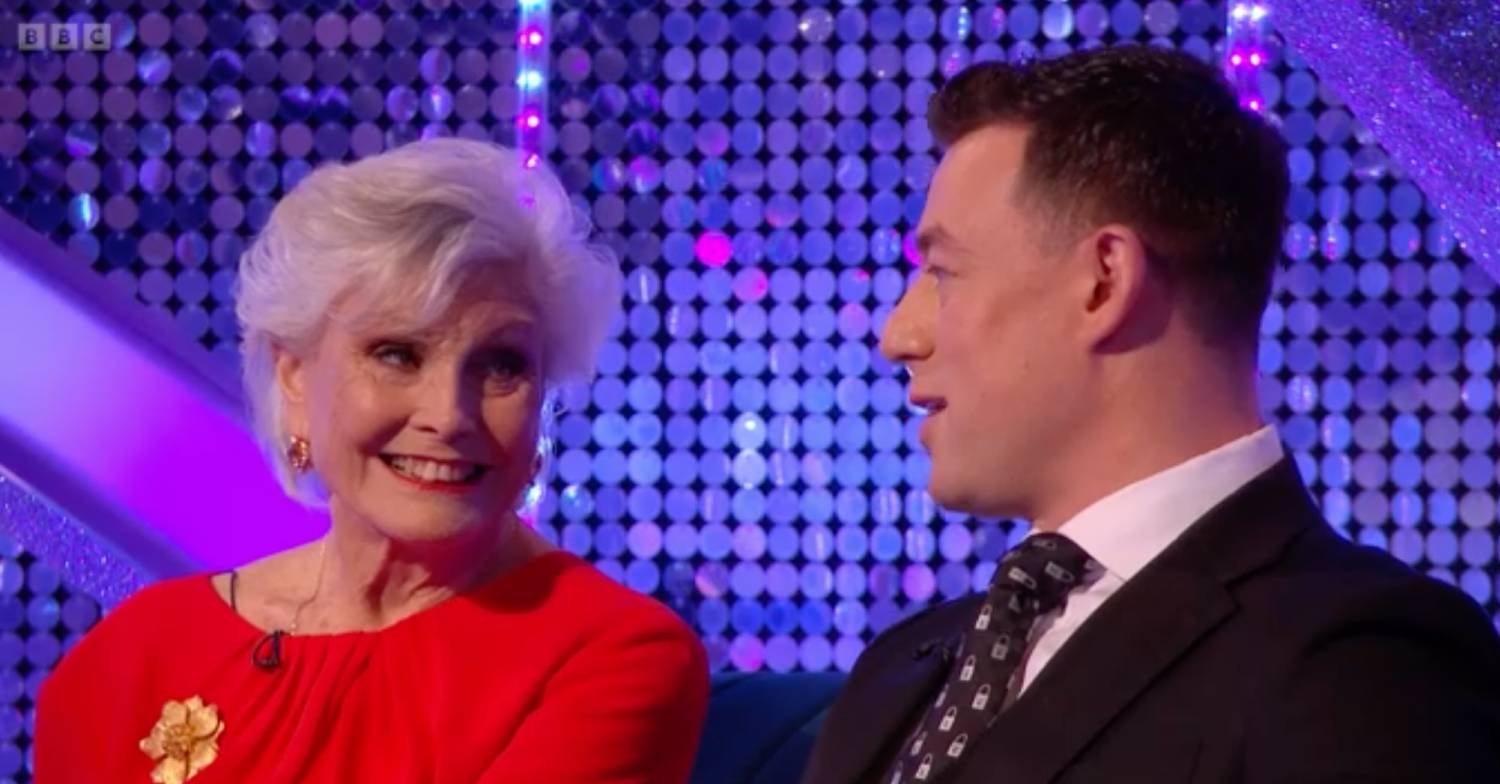 Angela Rippon listens as Strictly pro star Kai Widdrington speaks