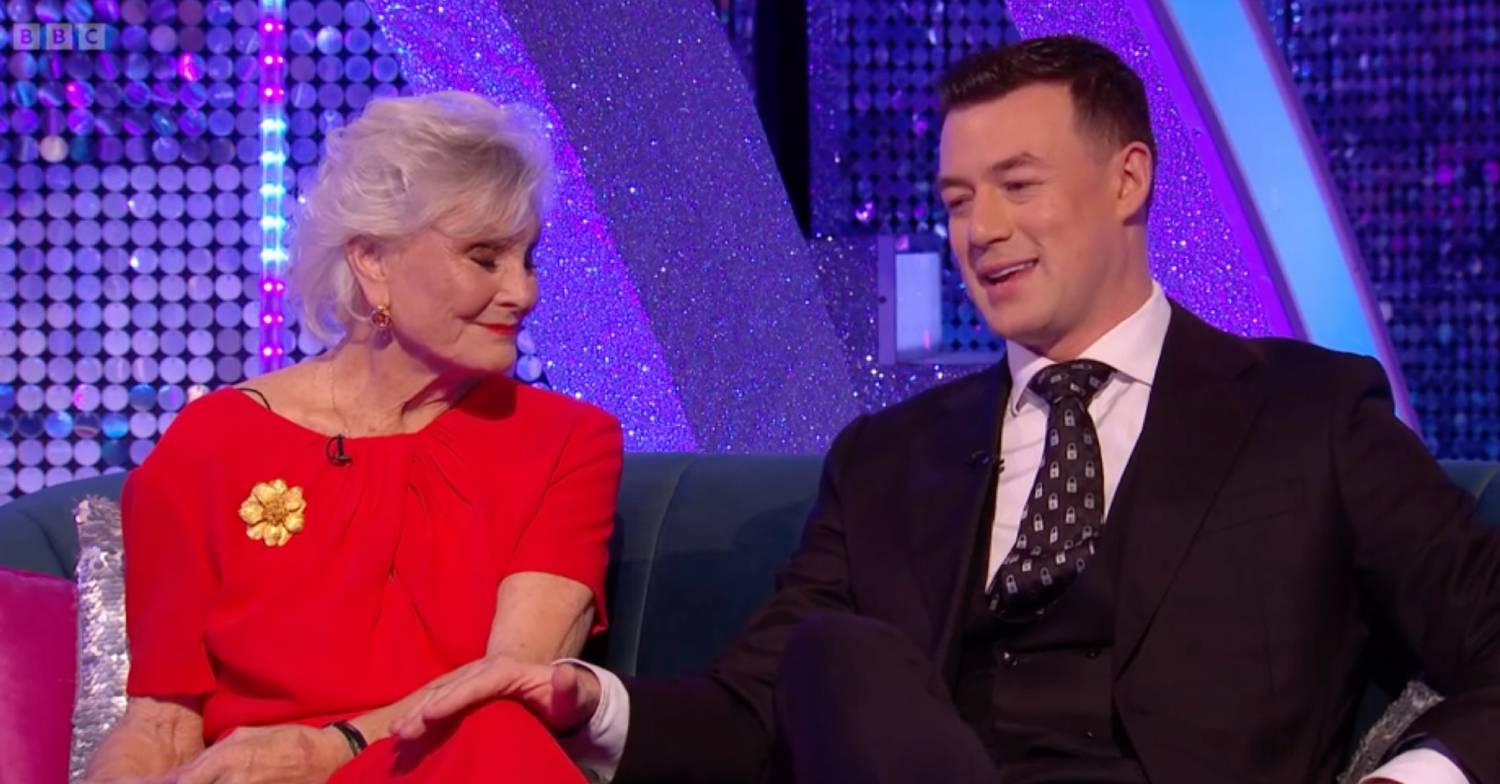 Angela Rippon listens as Strictly pro star Kai Widdrington speaks