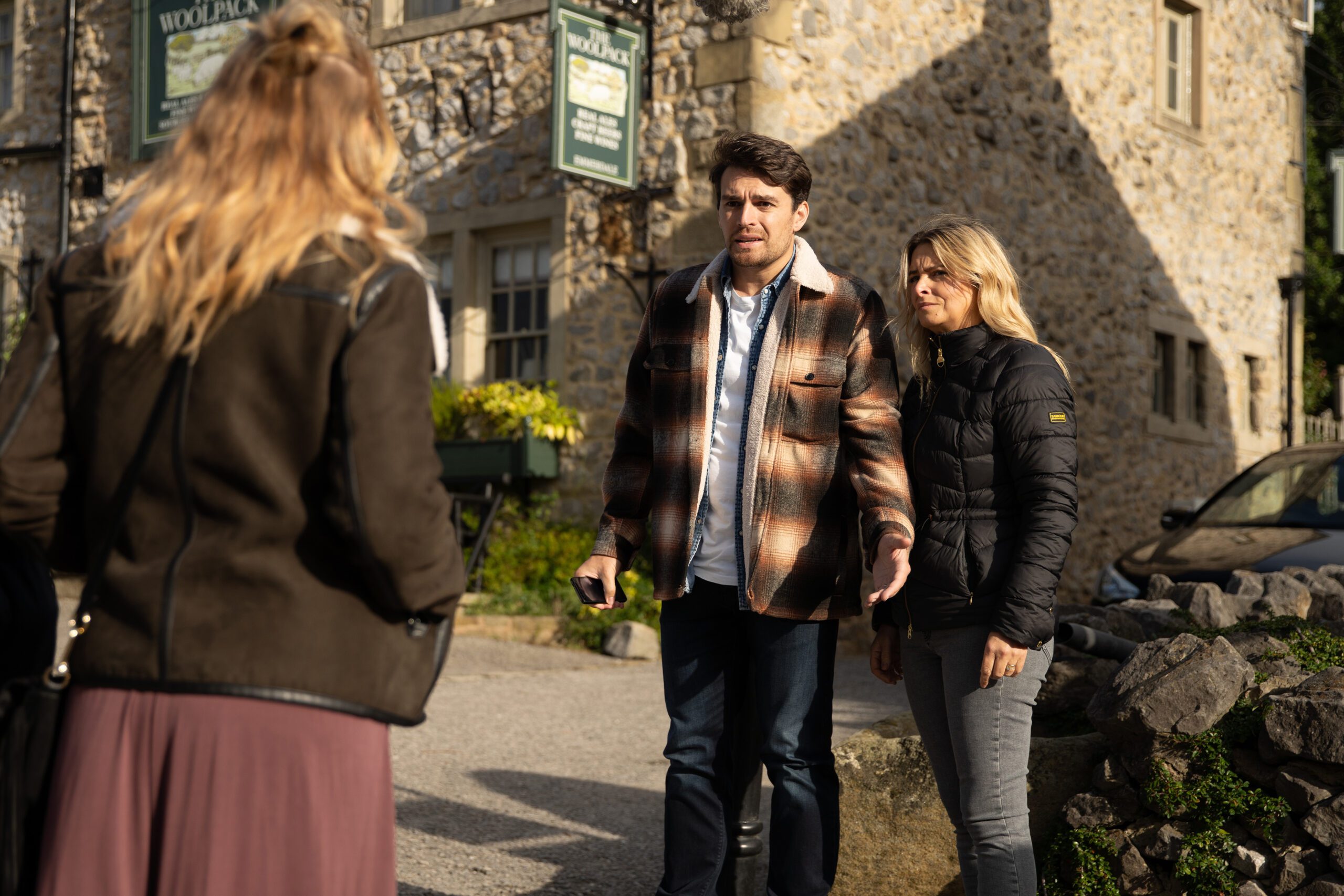 Emmerdale's Mack and Charity are talking to Amy outside