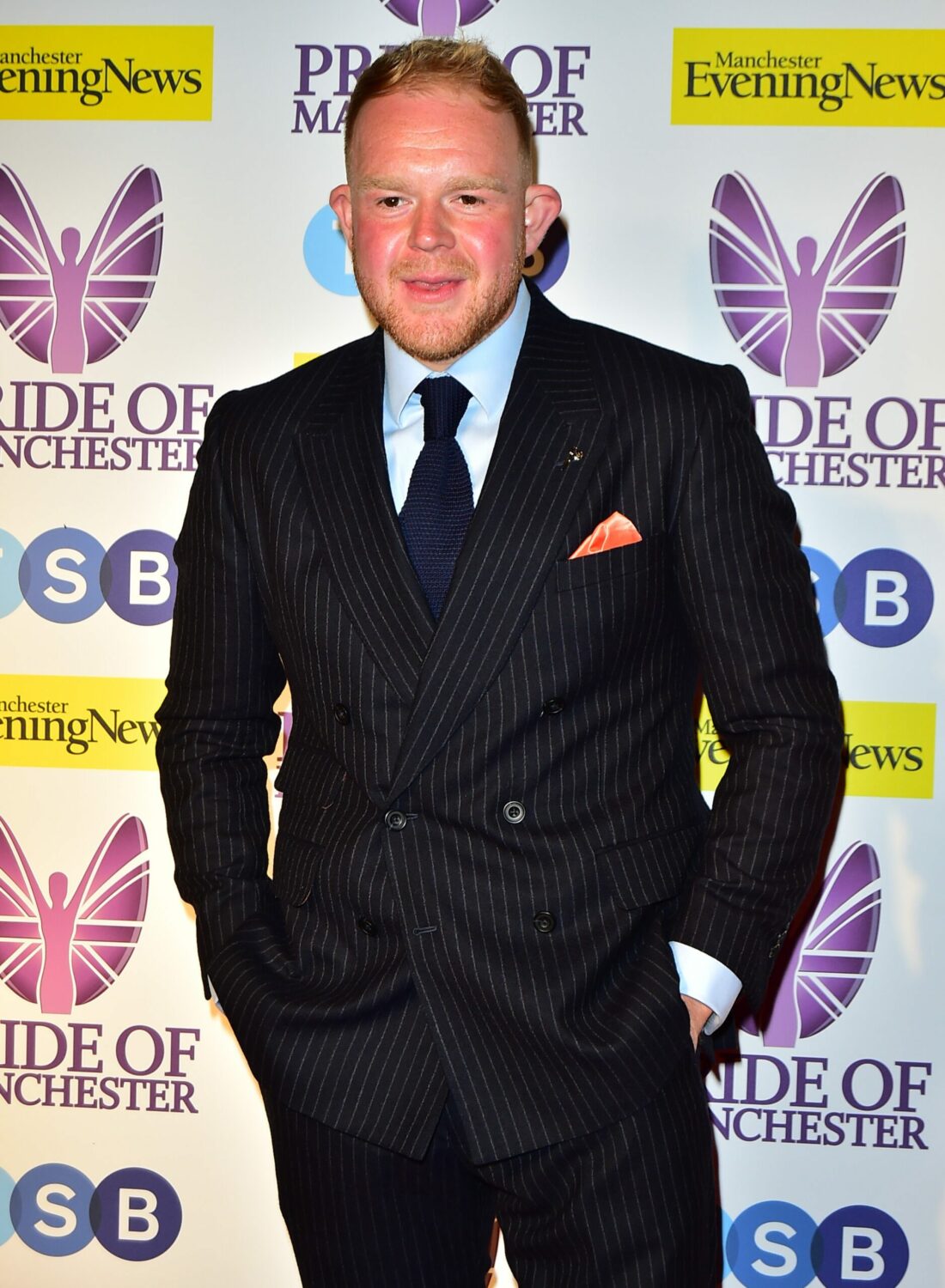 Coronation Street star Colson Smith smiles in a suit at the Pride of Manchester Awards