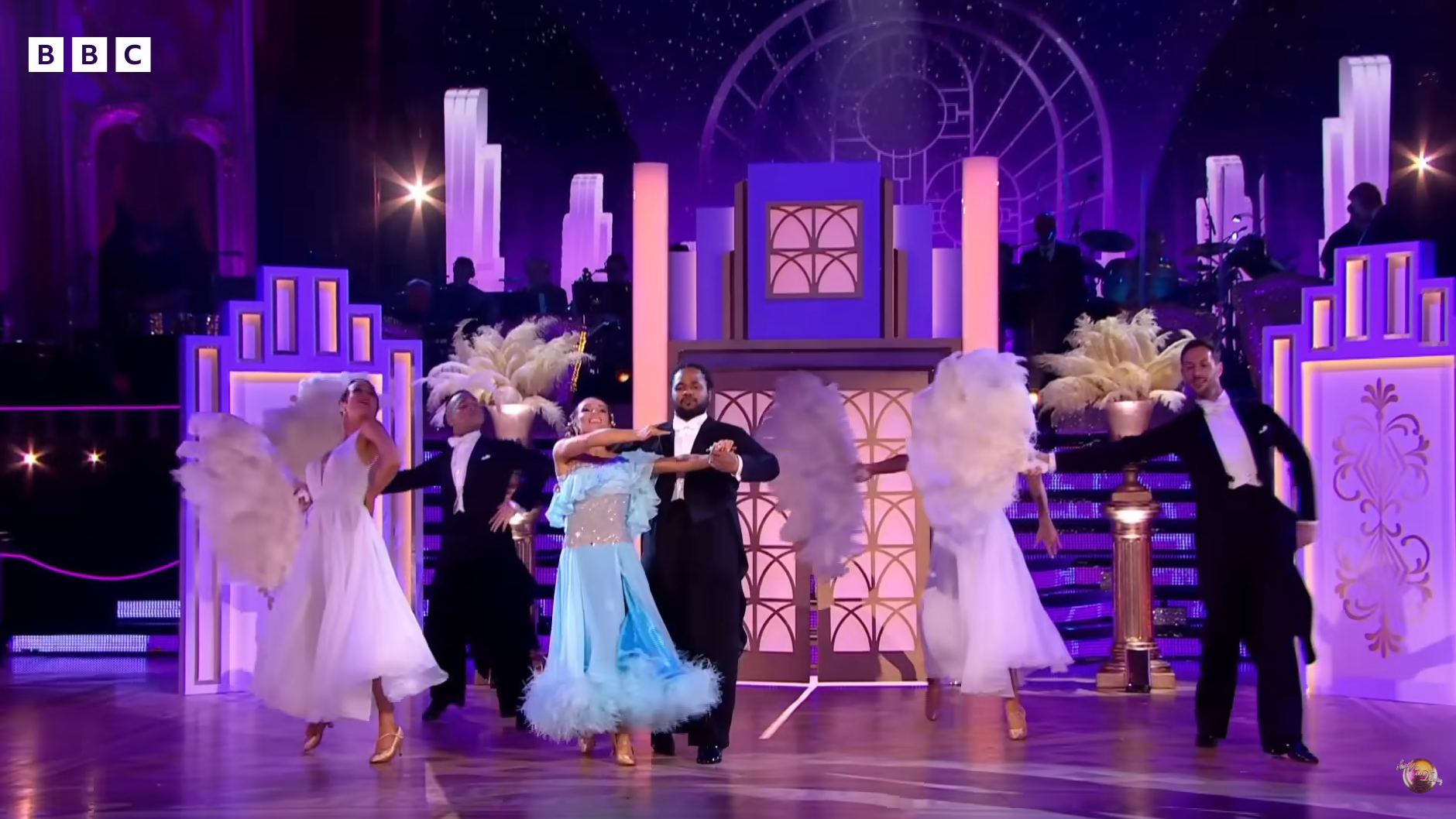 Hamza and Jowita perform an American Smooth with extra dancers