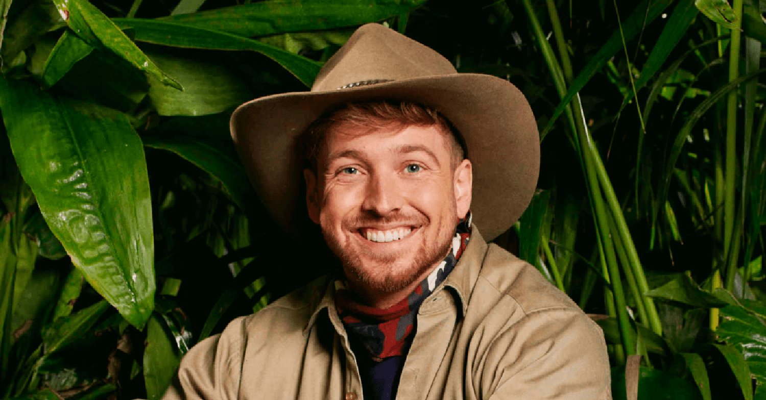 Sam Thompson smiling in his I'm A Celebrity outfit