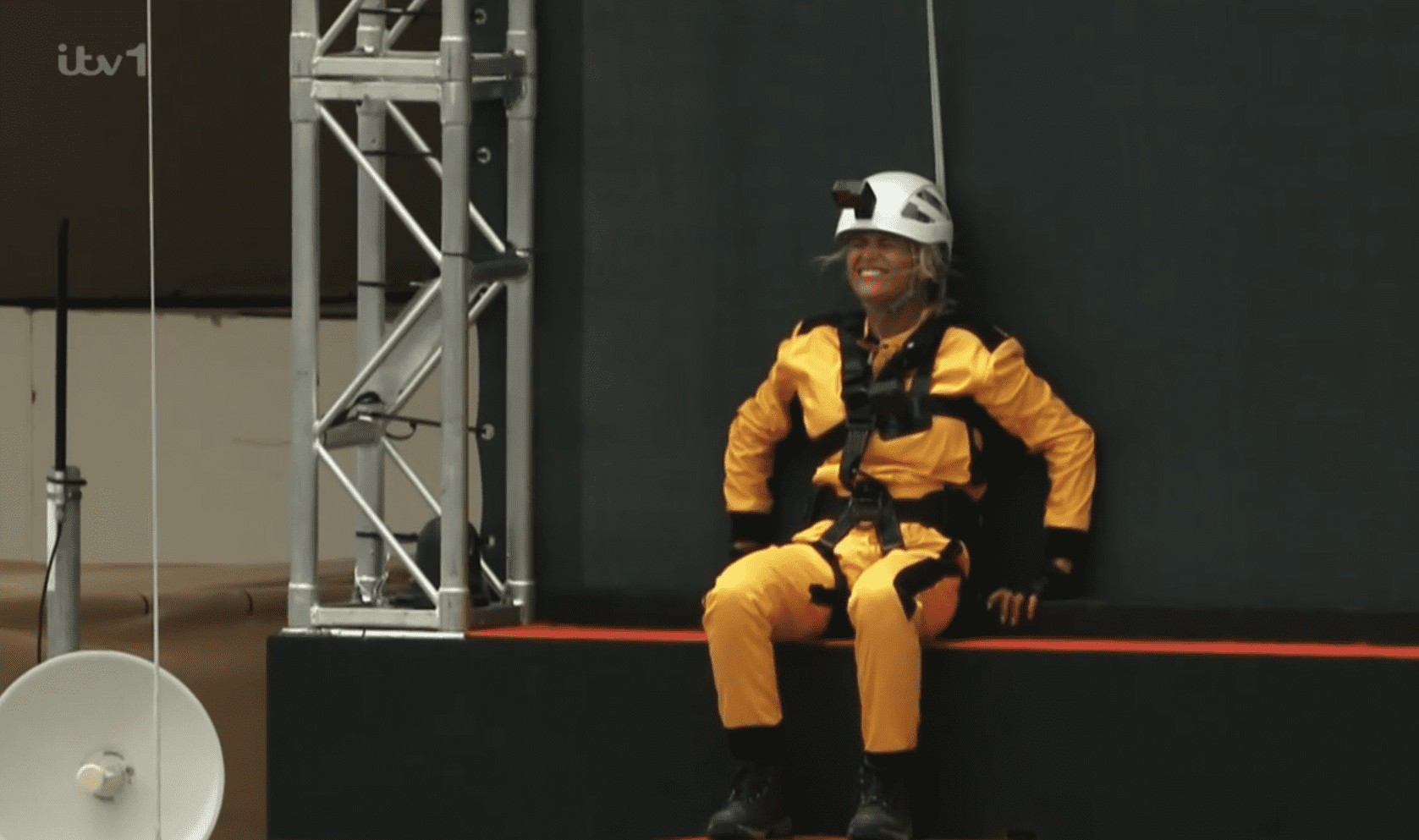 Danielle Harold perched at the edge of a tall building