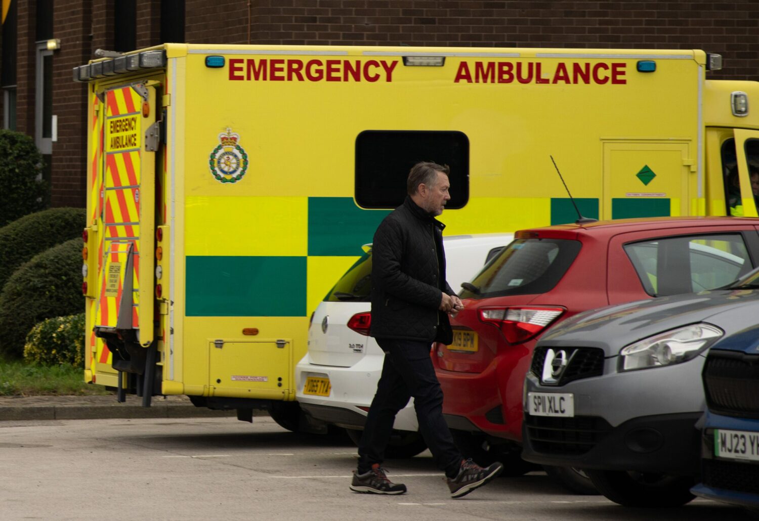 Gus walking through hospital car park on Emmerdale