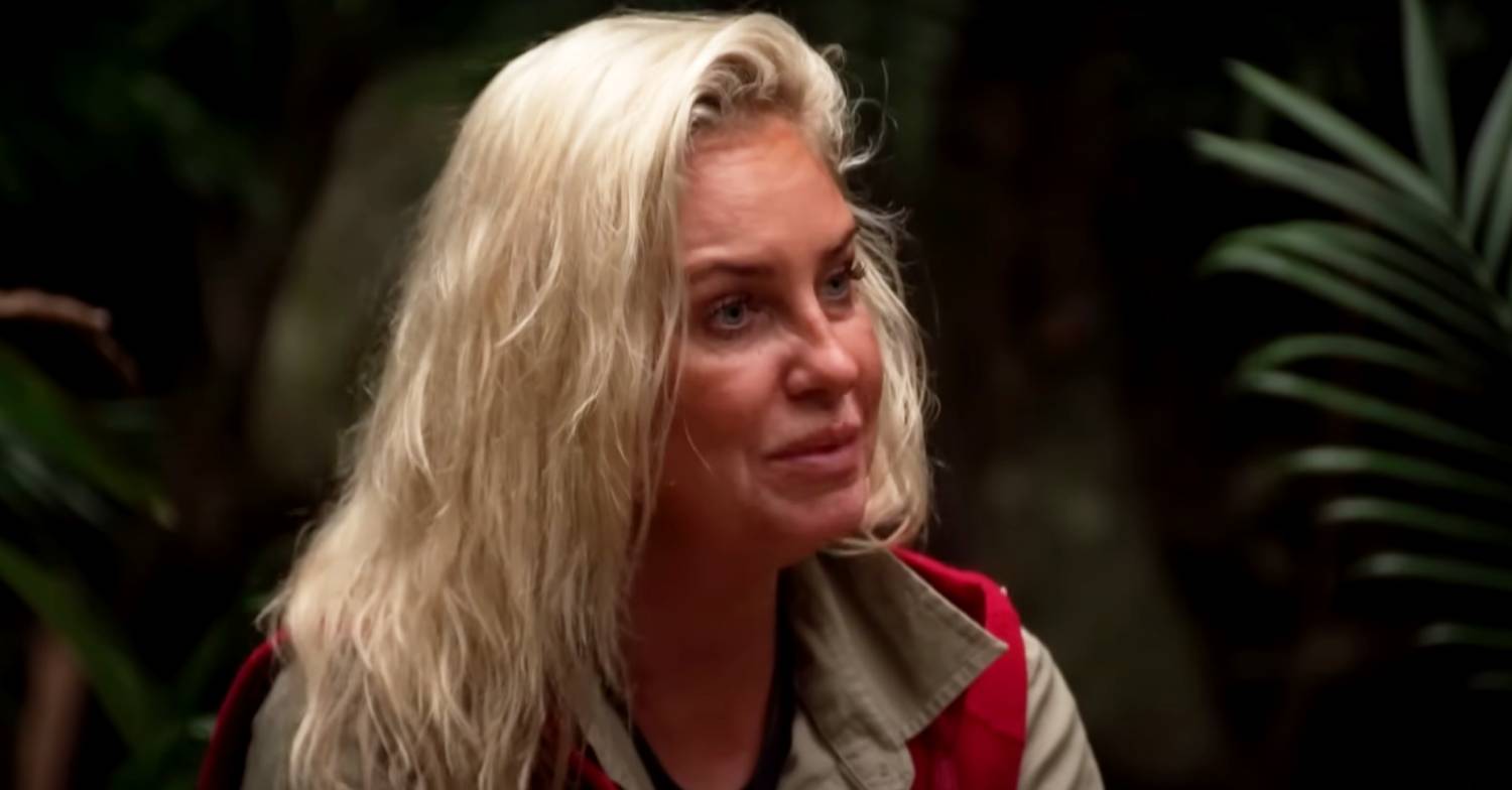 Josie Gibson listens in the camp