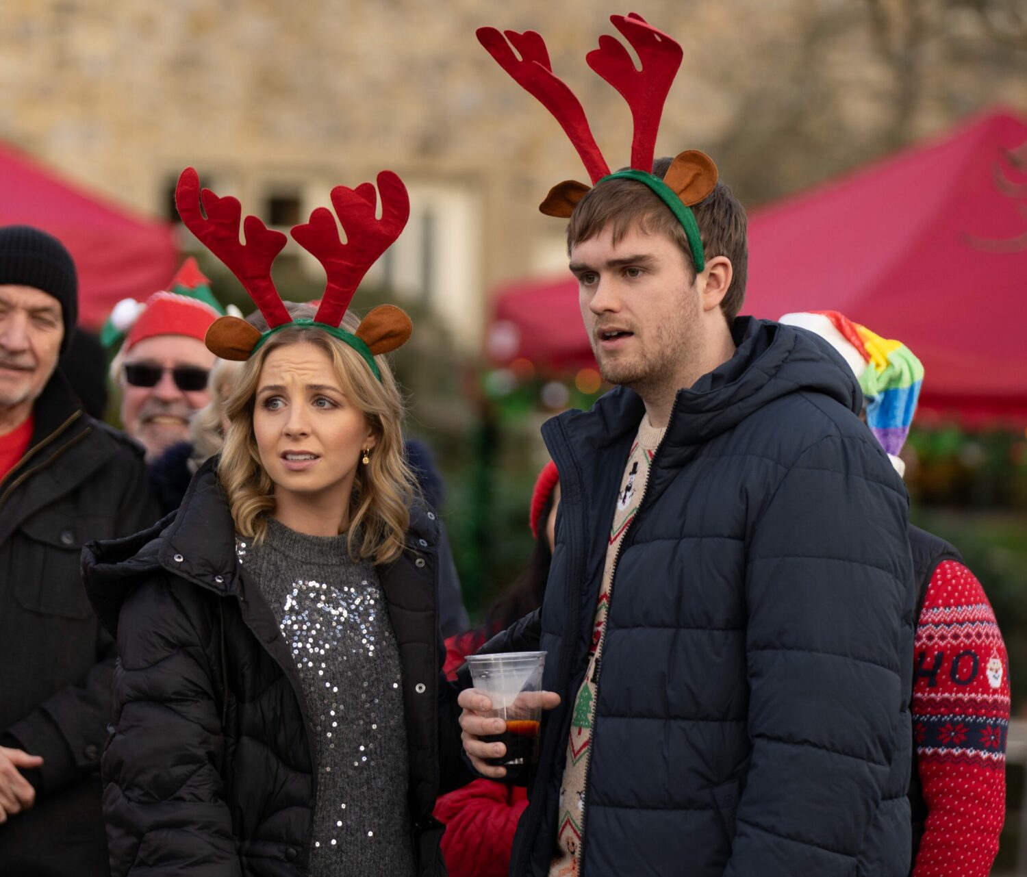 Emmerdale's Belle and Tom are in disbelief whilst wearing reindeer antlers