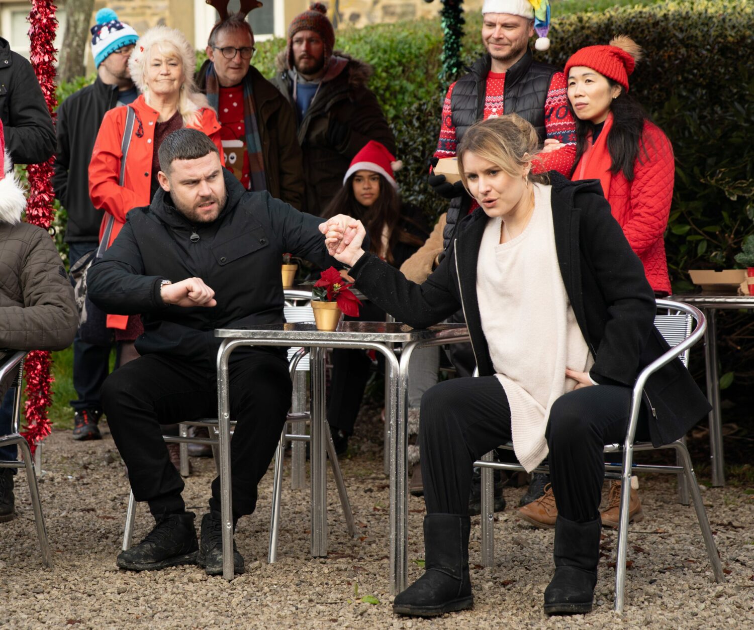 Aaron Dingle holds Dawn Fletcher's hand as she goes into labour at the Christmas fair.