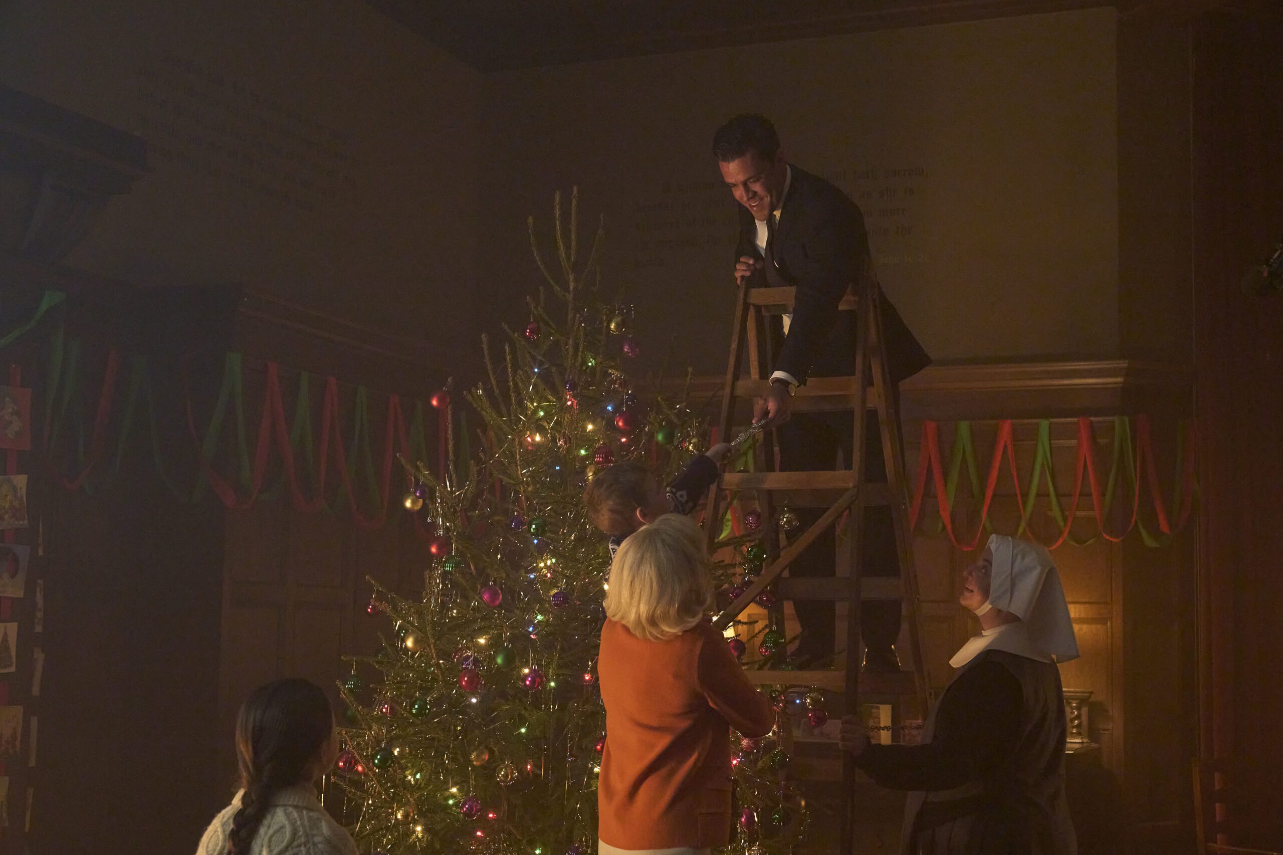 Matthew helps decorate a tree
