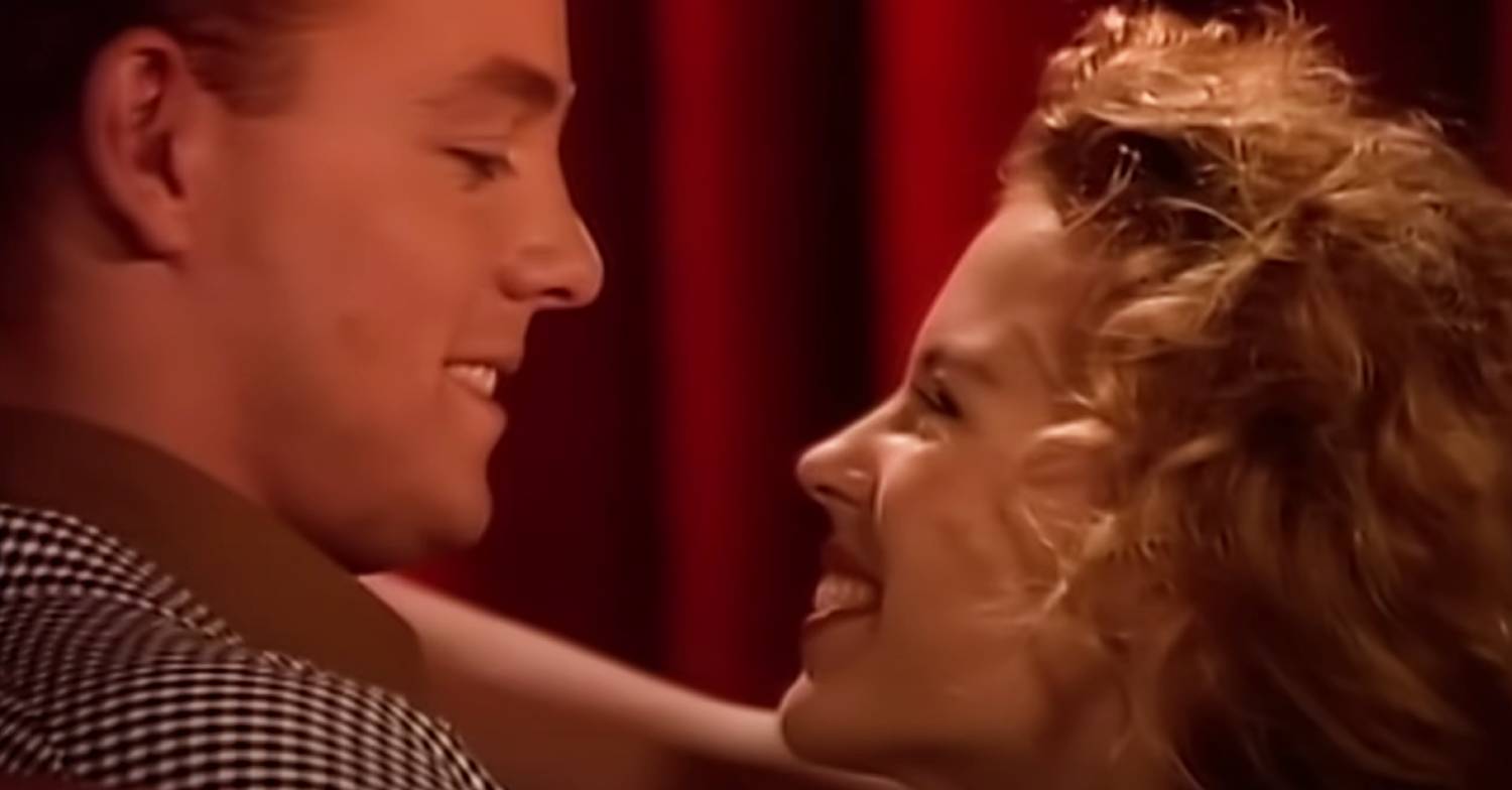 Kylie Minogue and Jason Donovan gaze at one another