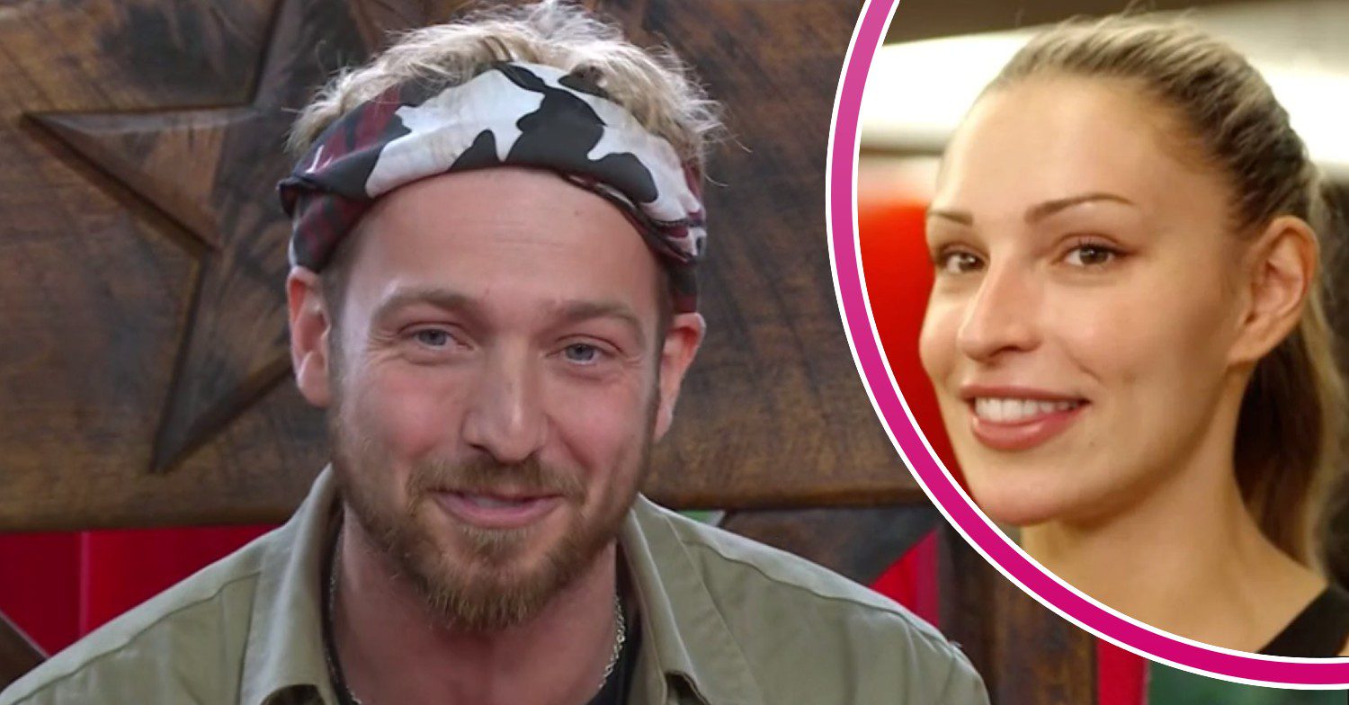 Sam Thompson, crowned King of the Jungle for winning I'm A Celebrity 2023, smiles. His girlfriend Zara McDermott also smiles
