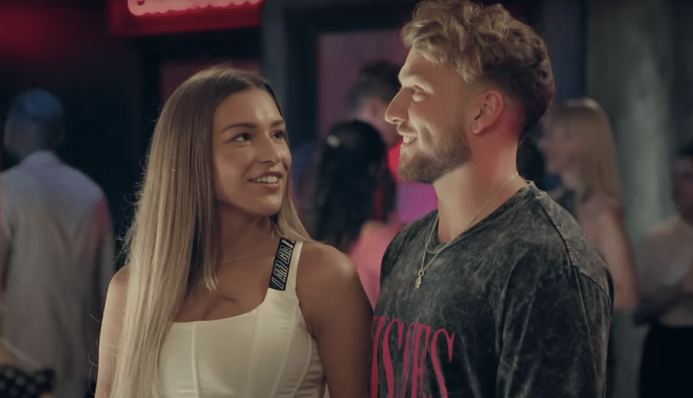 Zara McDermott and Sam Thompson smiling at each other