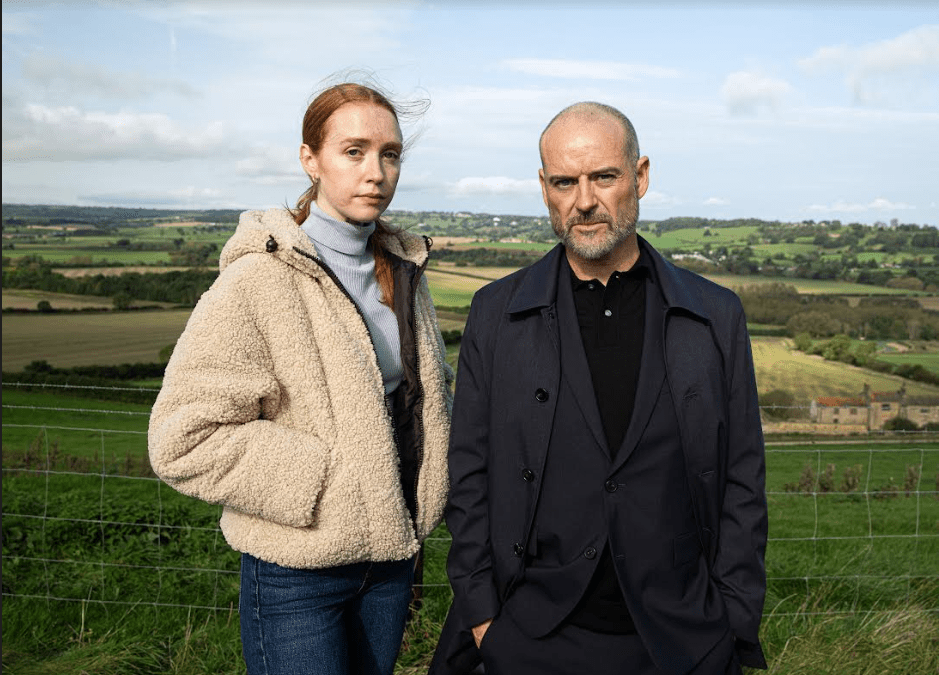 Emmerdale's Chloe and Harry are standing in a field together