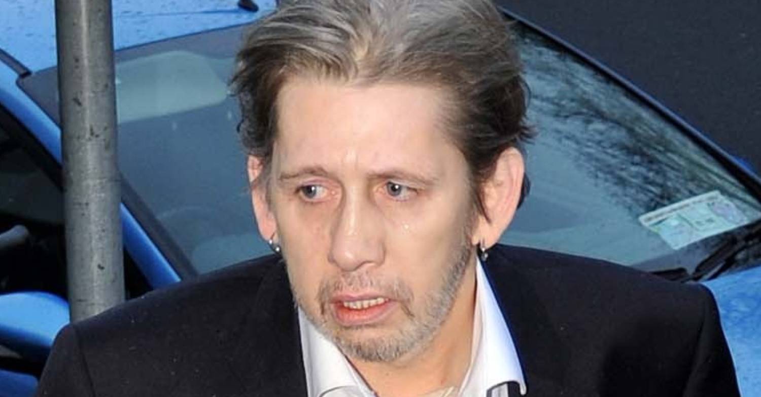 Shane MacGowan looks to his side