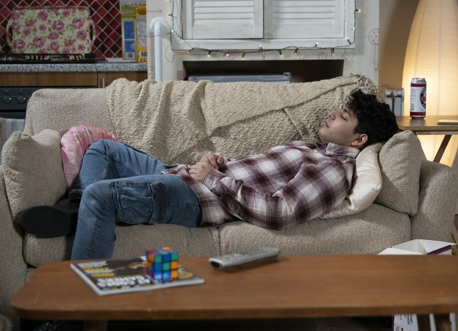 Aadi unconscious on the sofa in Corrie