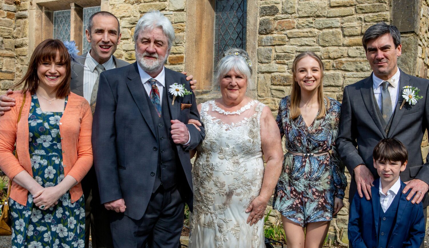 Lydia, Sam, Zak, Lisa, Belle, Cain and Kyle Dingle in a wedding picture