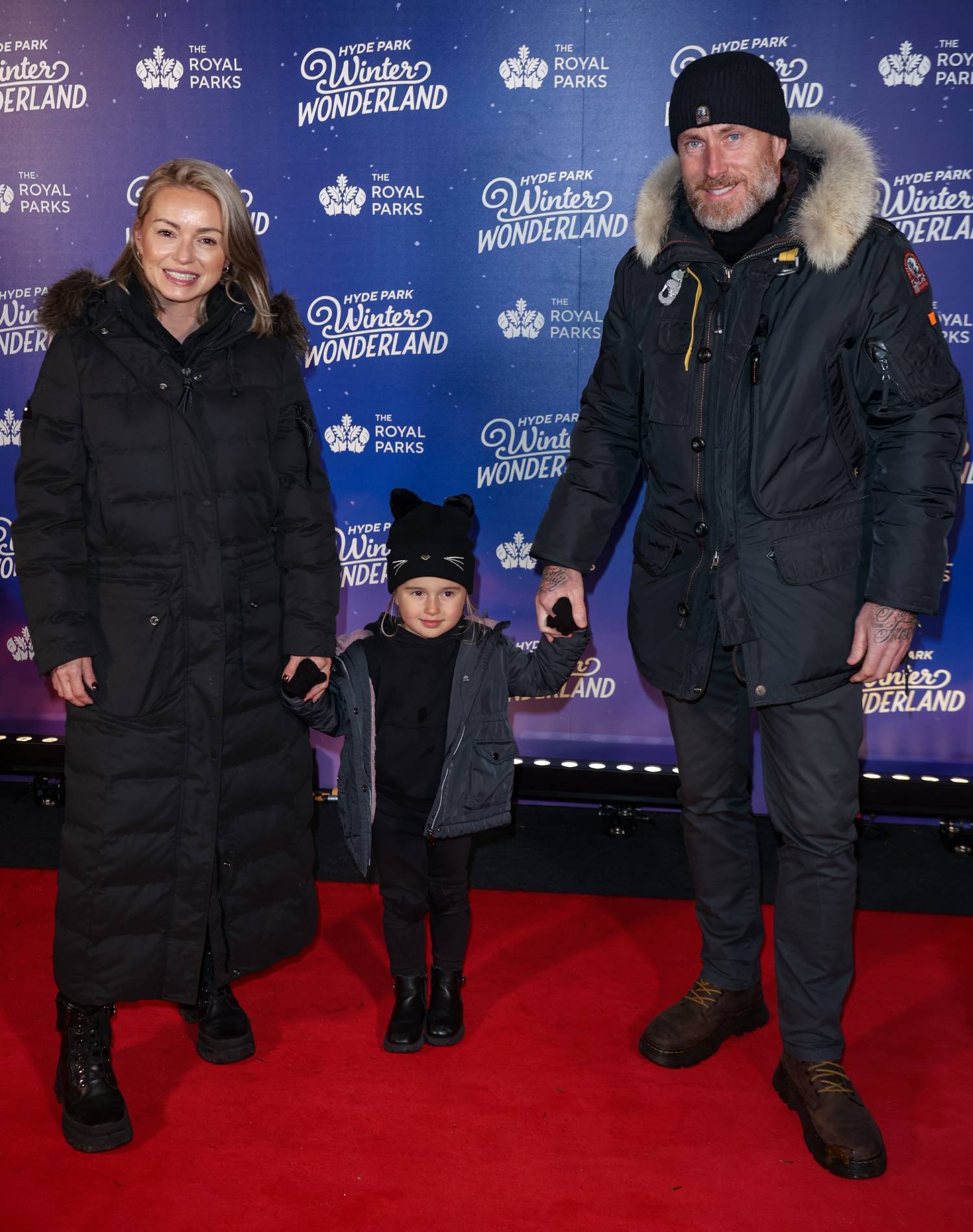 Ola Jordan and James Jordan hold hands with their daughter Ella in November 2023