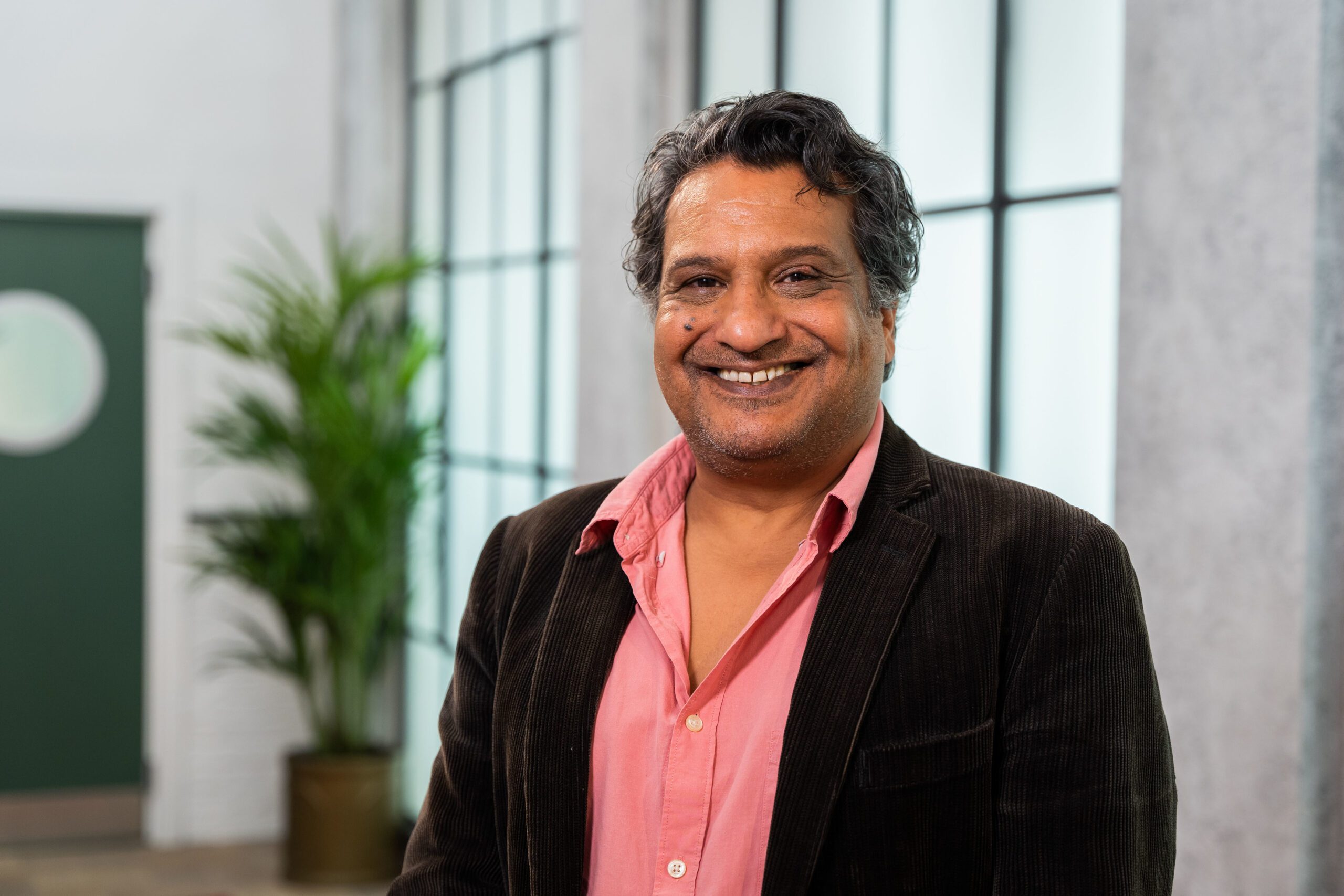 Kulvinder Ghir smiles at camera