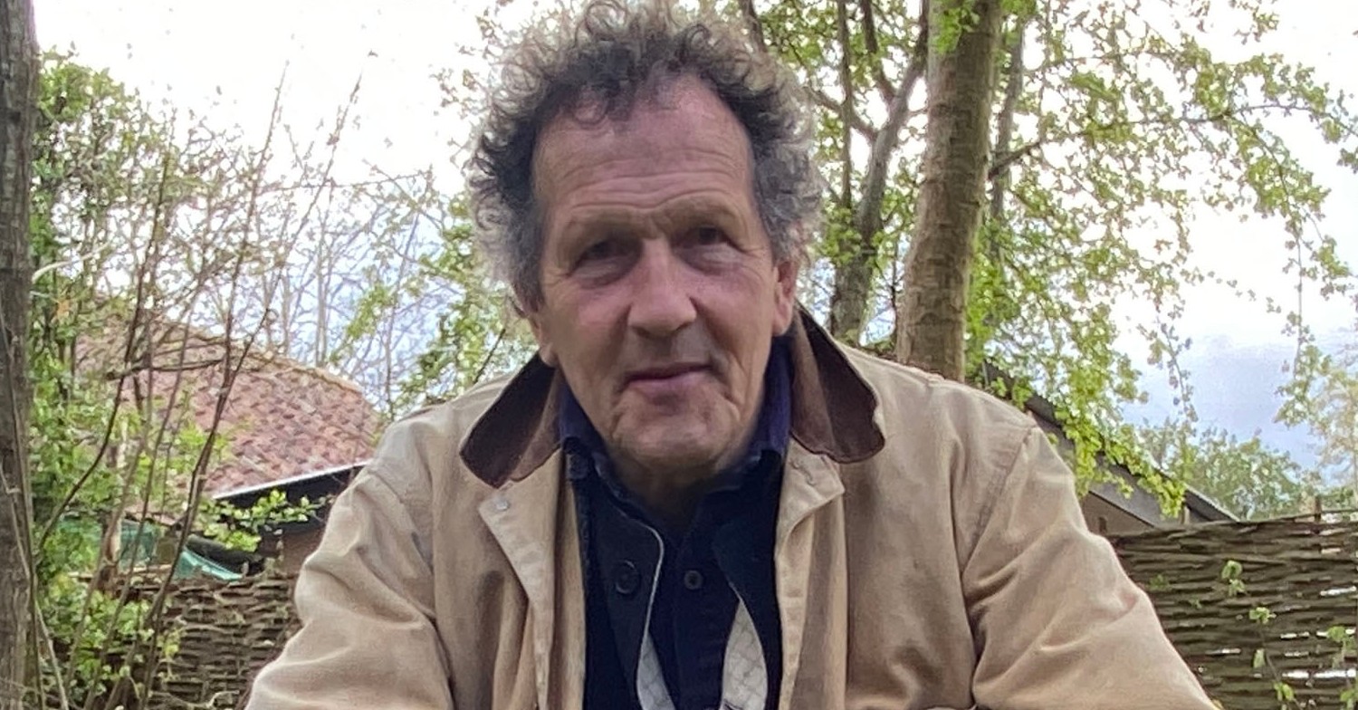 Monty Don in a beige coat in the garden