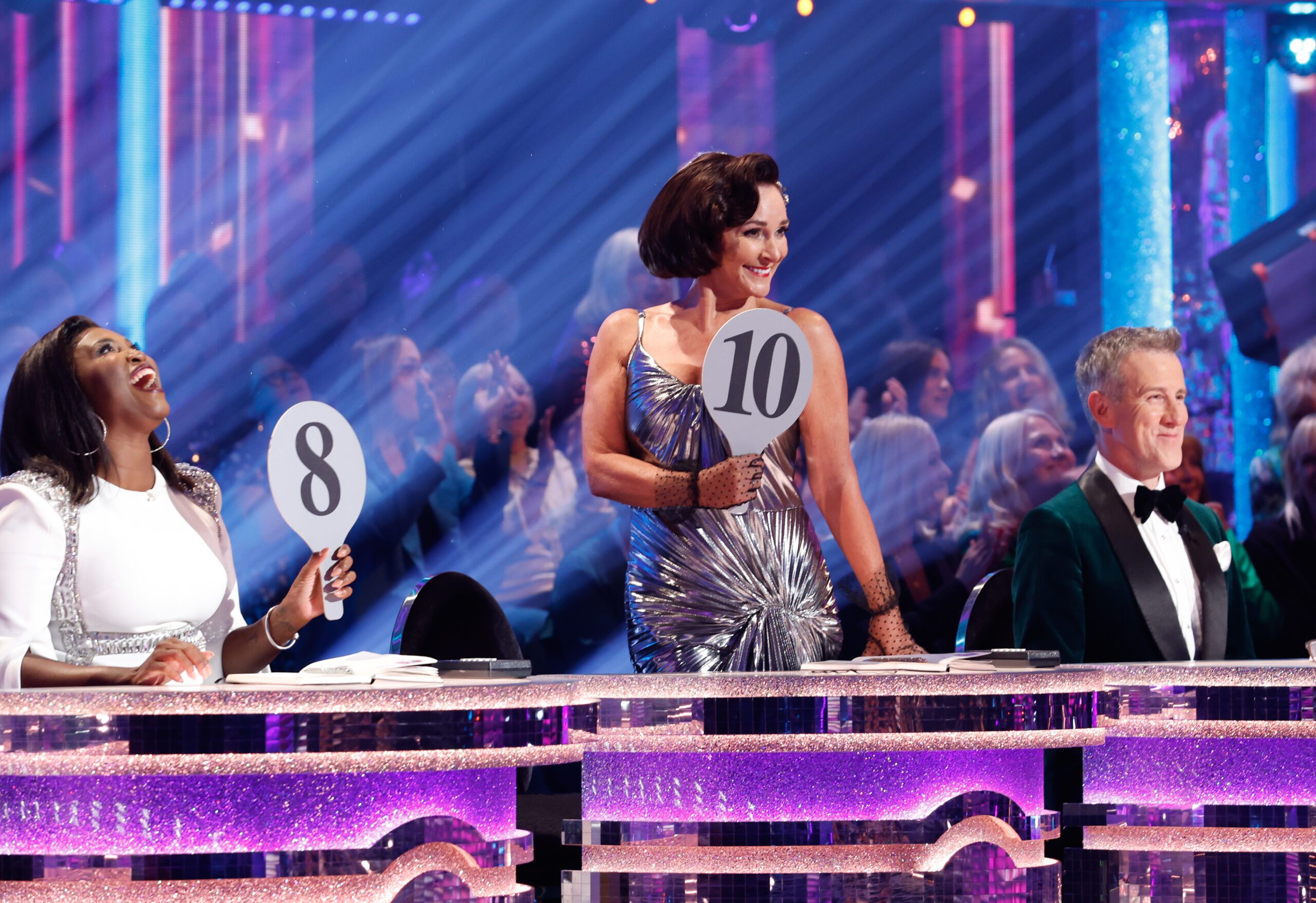 Shriley Ballas on Strictly Come Dancing in a silver dress with a 10 paddle