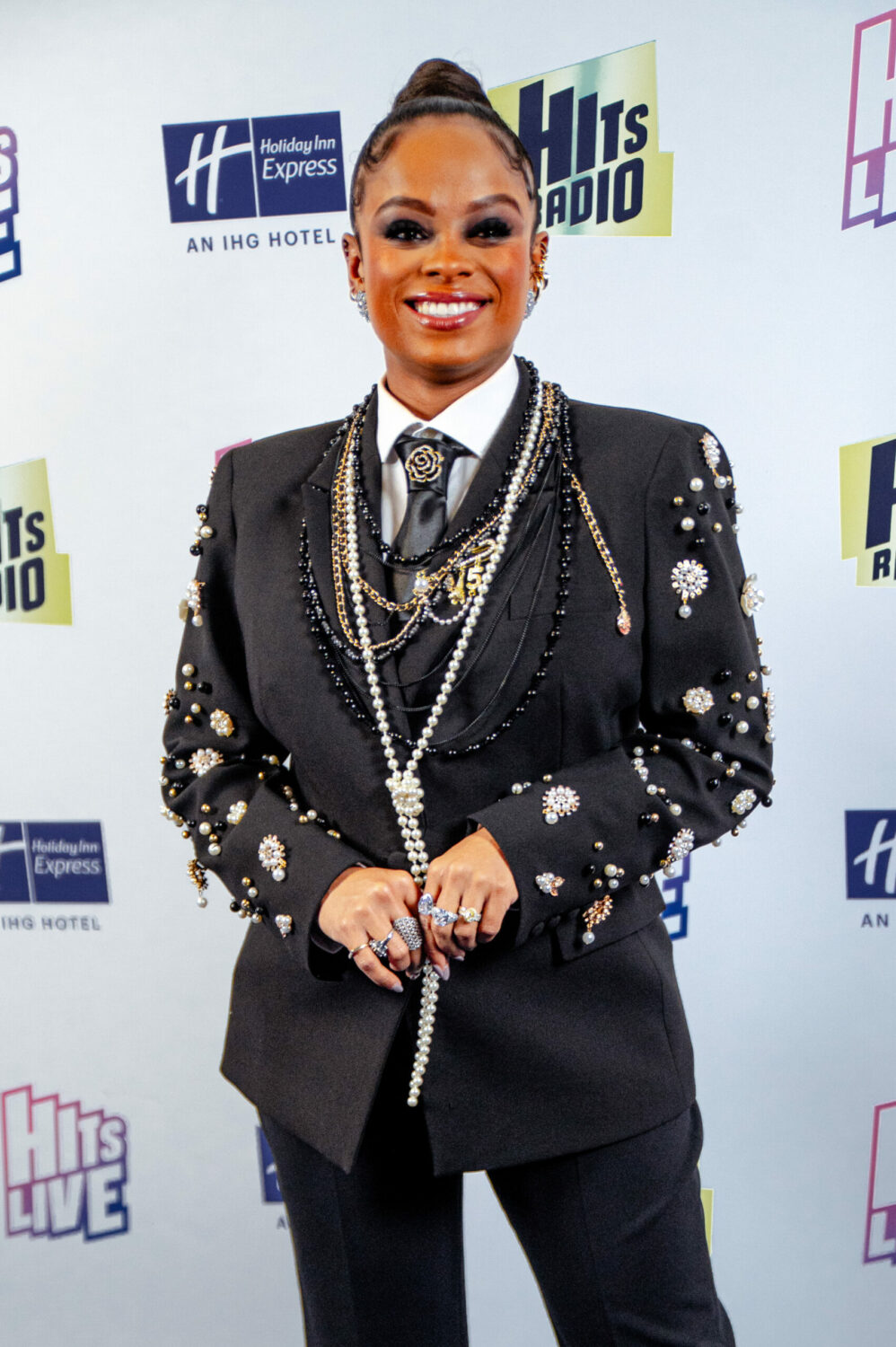 Fleur East smiles in a dramatic black outfit