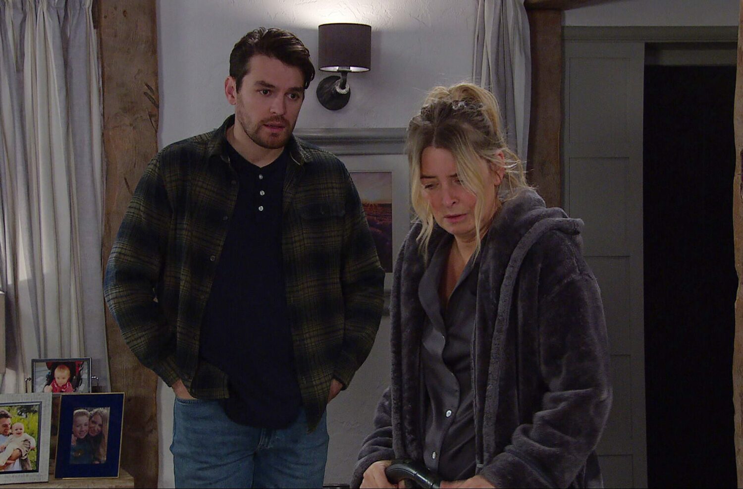 Mackenzie Boyd looks worried as he watches upset Charity Dingle cleaning