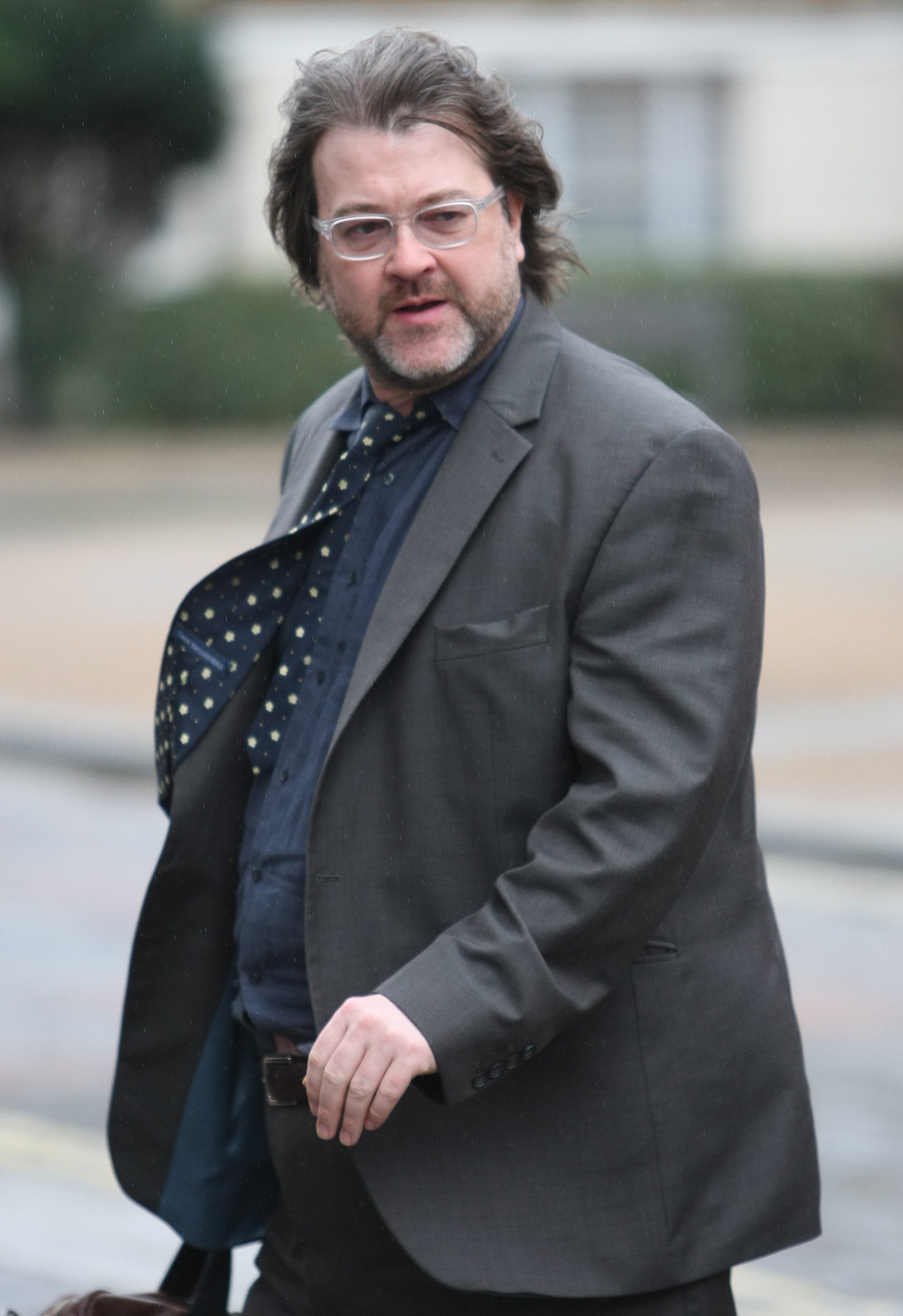 Derek Draper in a suit walking in the street