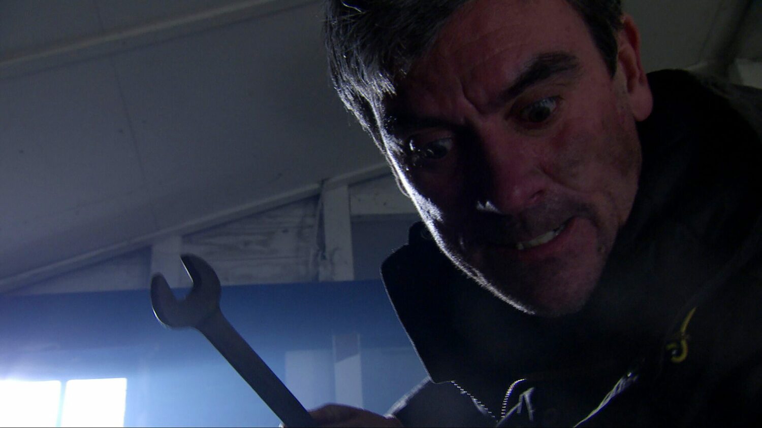 Aaron Dingle [DANNY MILLER] throwing further disrespect in Cain Dingle’s [JEFF HORDLEY] direction soon they have a brutal fight in the garage, Cain pins Aaron down, unsure whether to finish it.