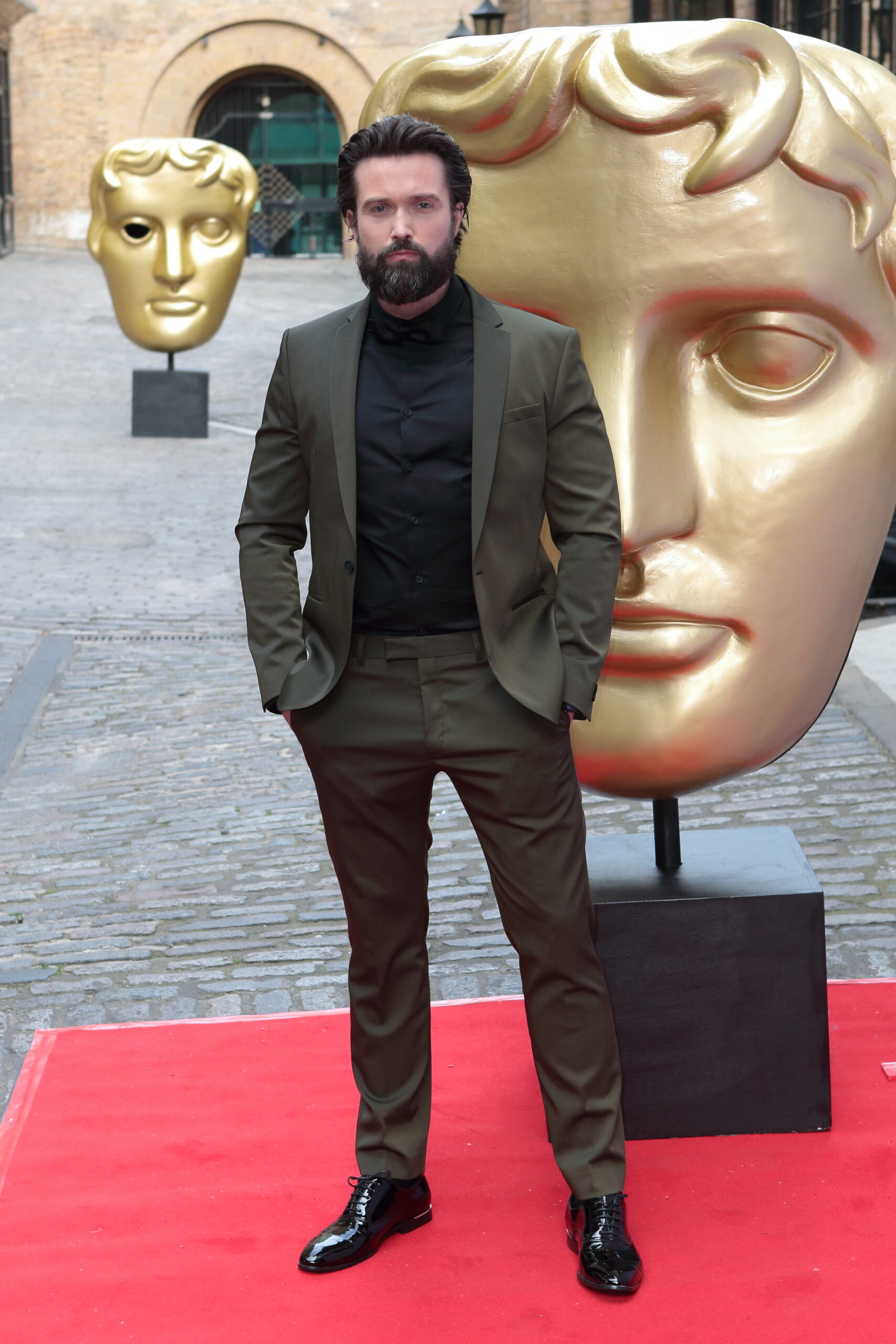 Emmett J Scanlan at the BAFTAS in a suit
