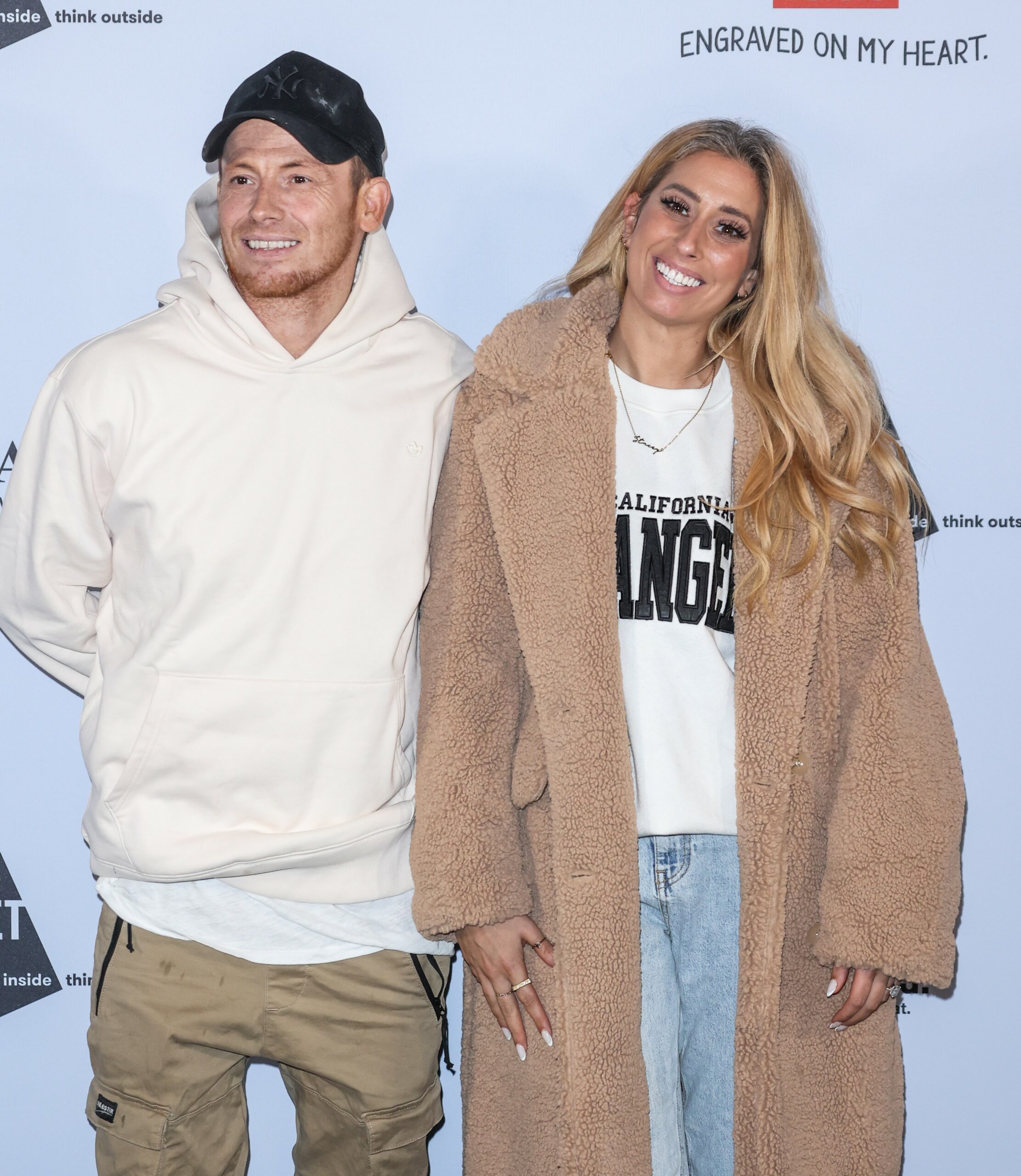 Joe Swash and Stacey Solomon smiling at event