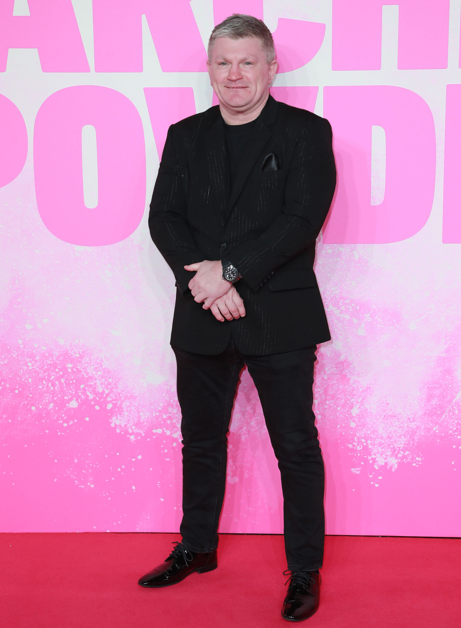 Ricky Hatton standing against a pink background