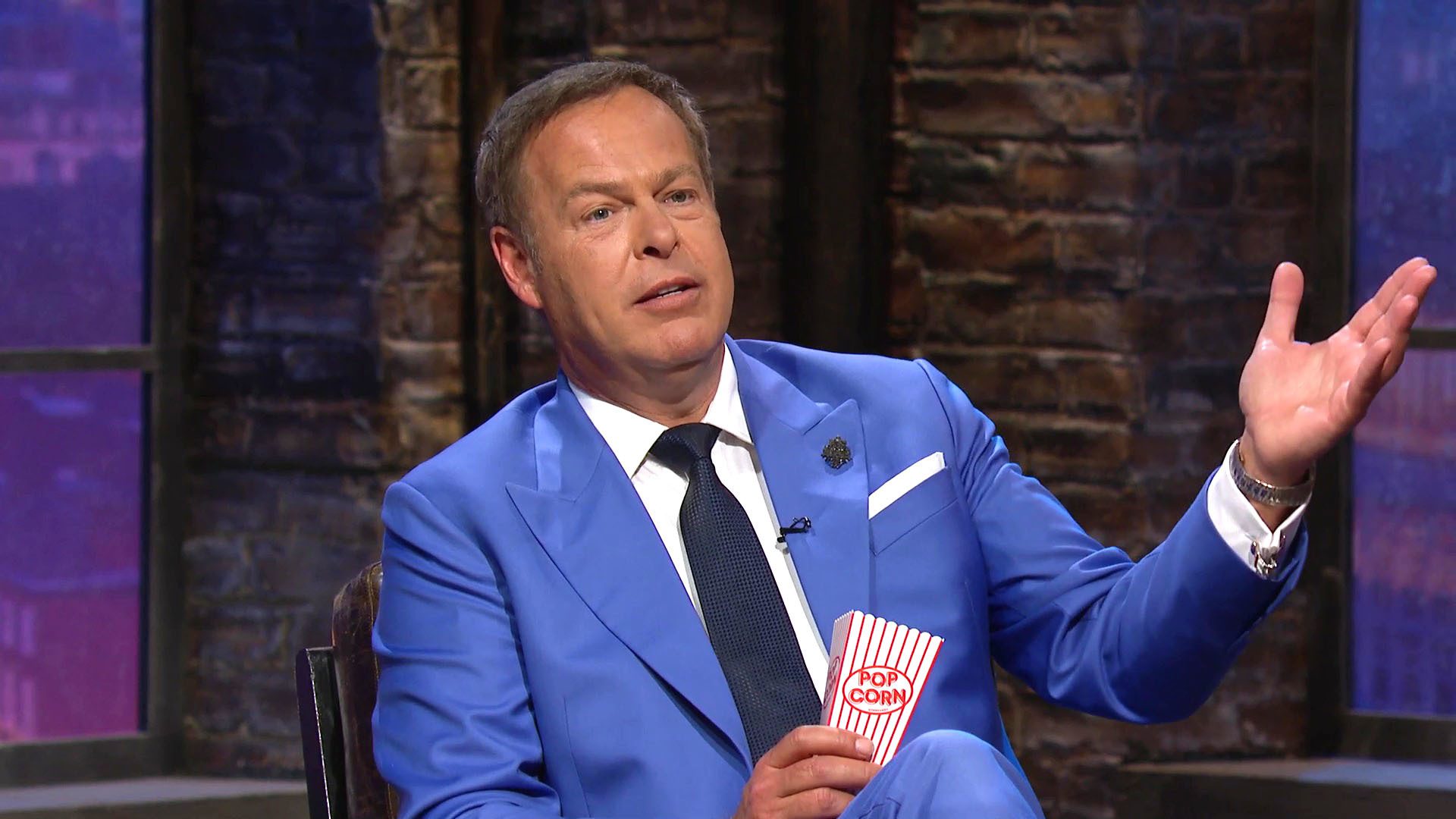 Peter Jones chomps on popcorn on Dragons' Den