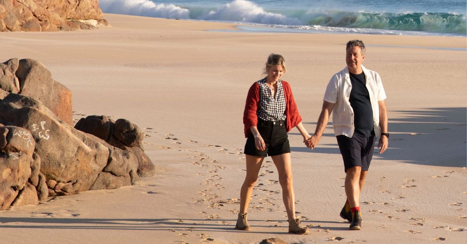 Lisa Faulkner and John Tarode holding hands on the beach