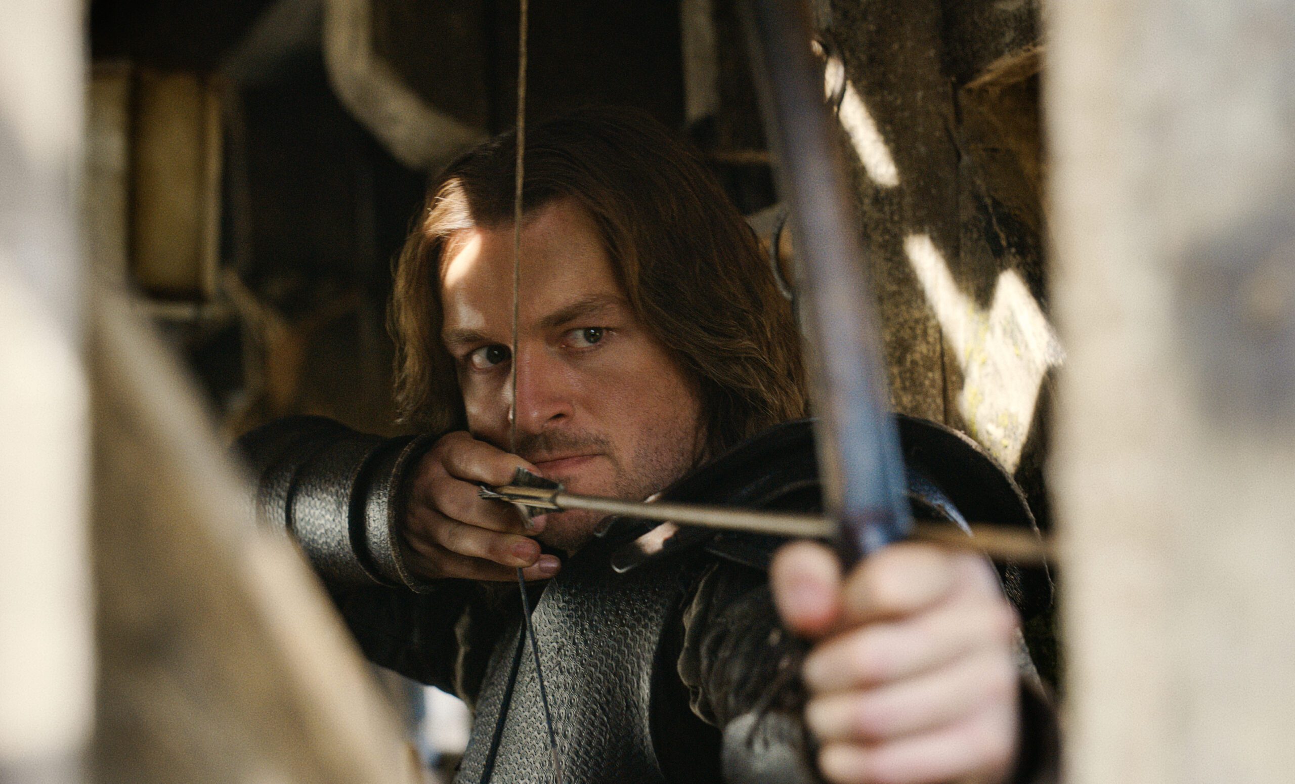 Matt Stokoe as Gawain firing an arrow in Netflix''s Cursed