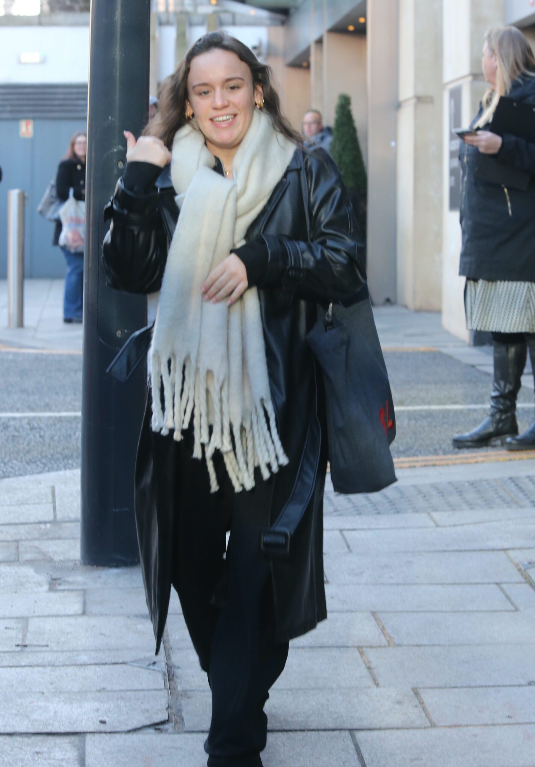 Ellie Leach wearing a scarf and coat
