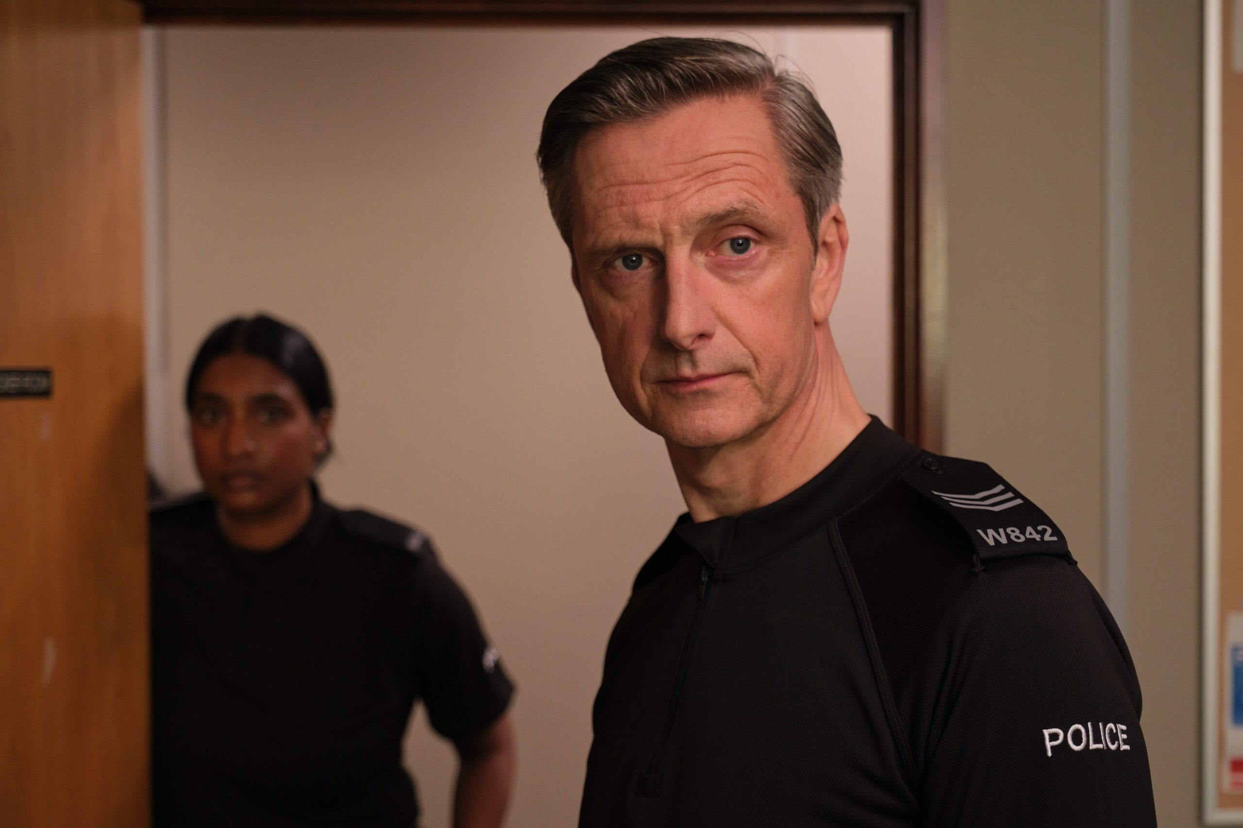 Nicholas Gleaves as Sergeant Phil Mackie and Tripti Tripuraneni as Deepa Das in After the Flood