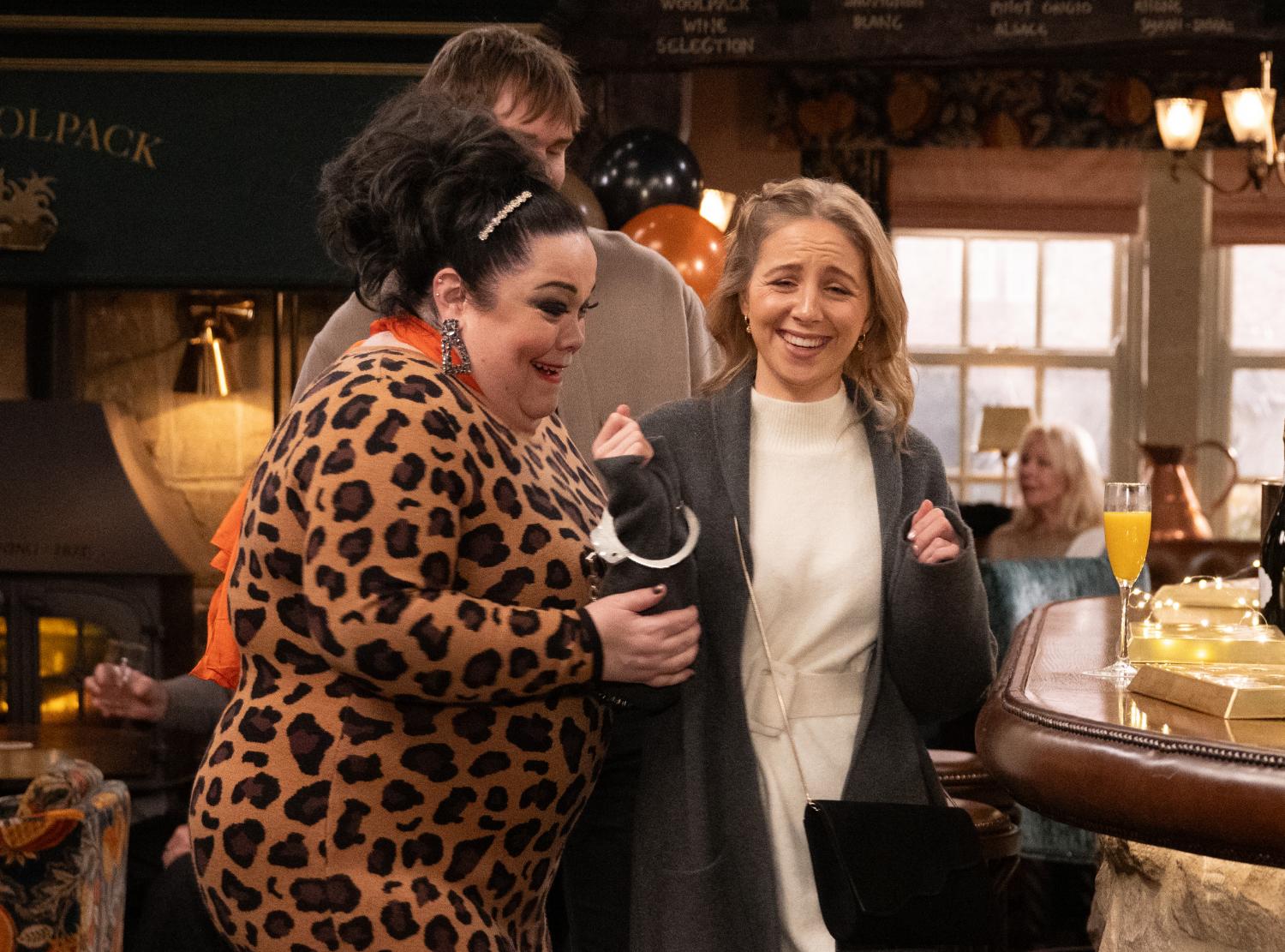 Emmerdale's Mandy is handcuffing Belle in the Woolpack