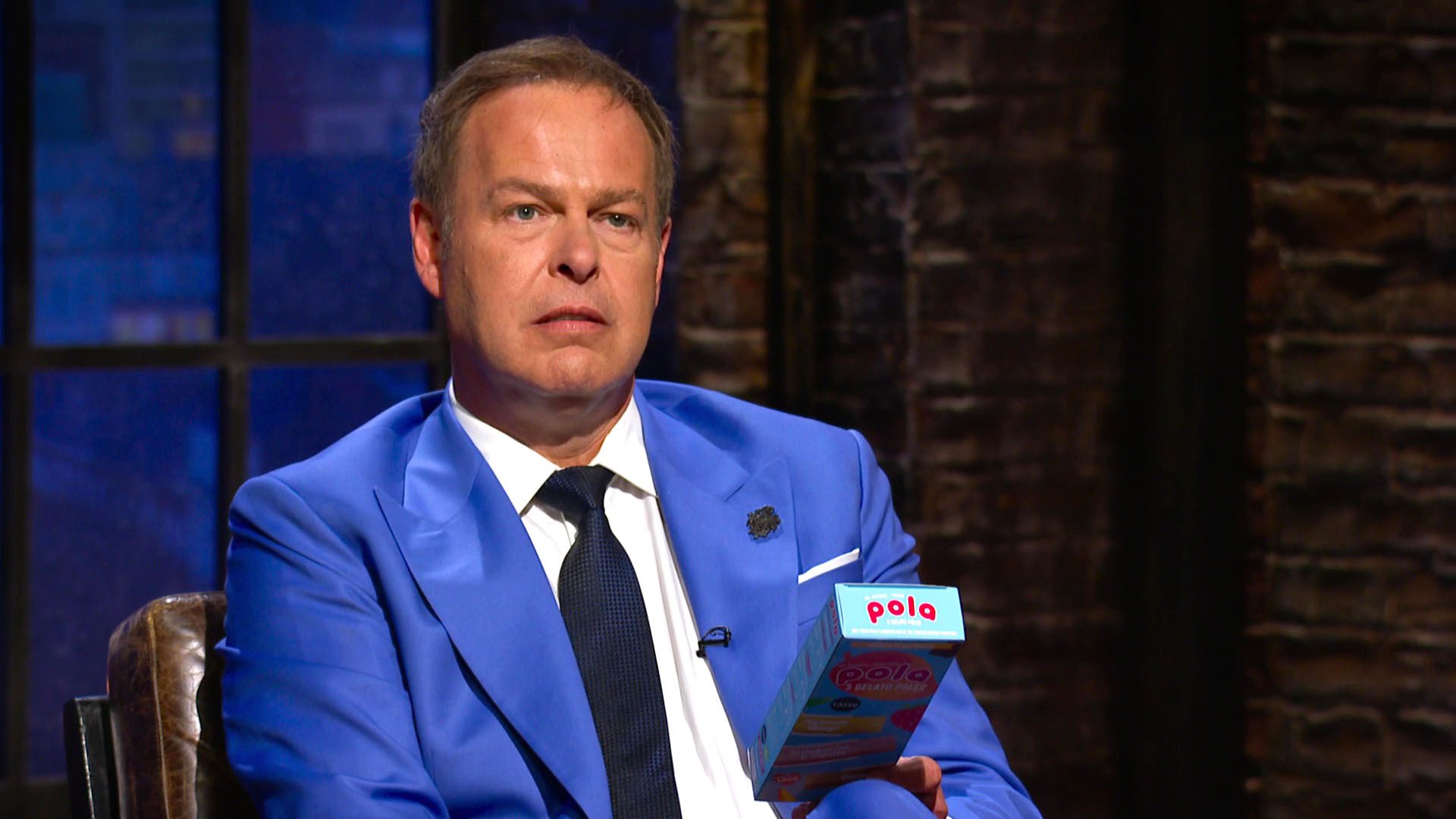 Peter Jones holding a product on Dragons' Den