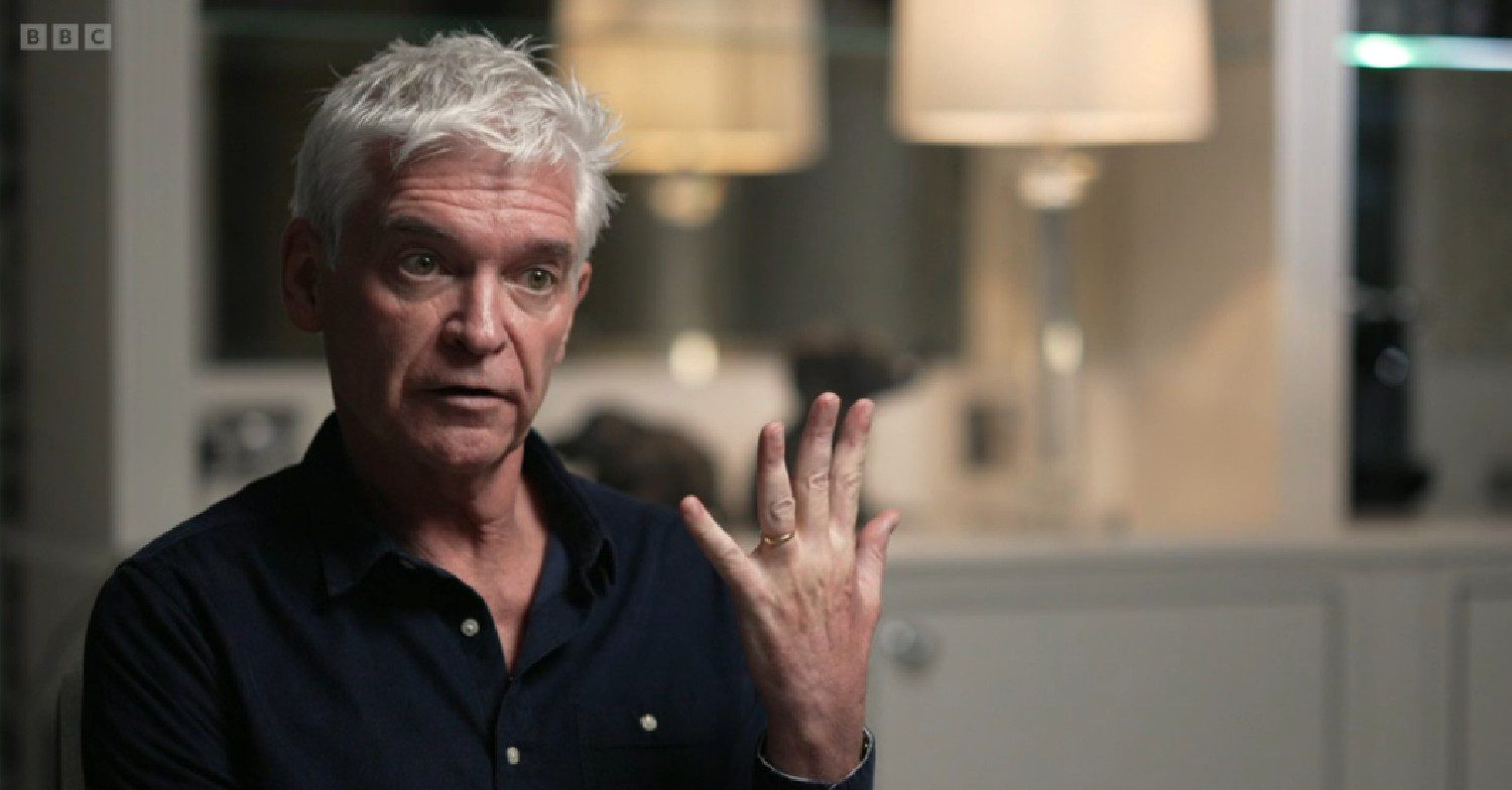 Phillip Schofield holding his hand up in BBC interview