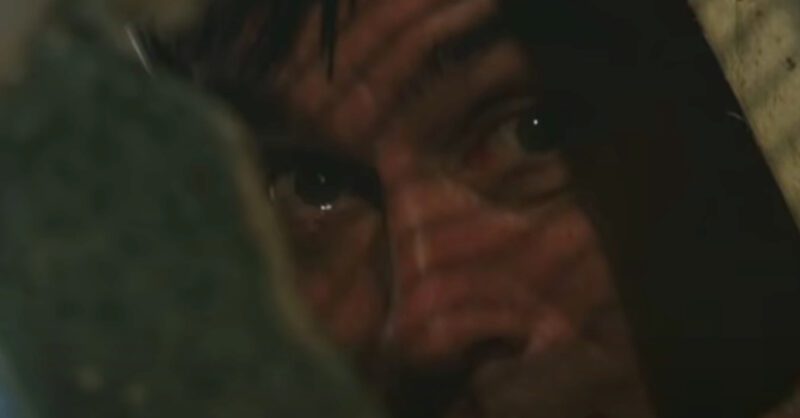 Emmerdale's Cain is peering through a gap in the wreckage