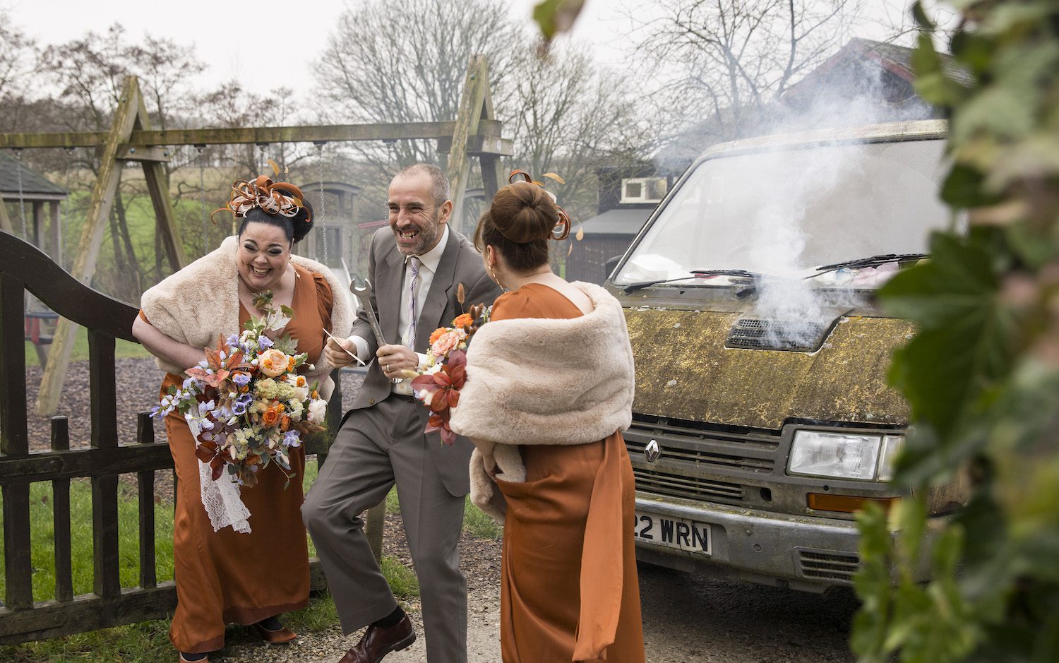 Mandy, Sam and Lydia Dingle laugh as they run to the church with the van smoking behind them