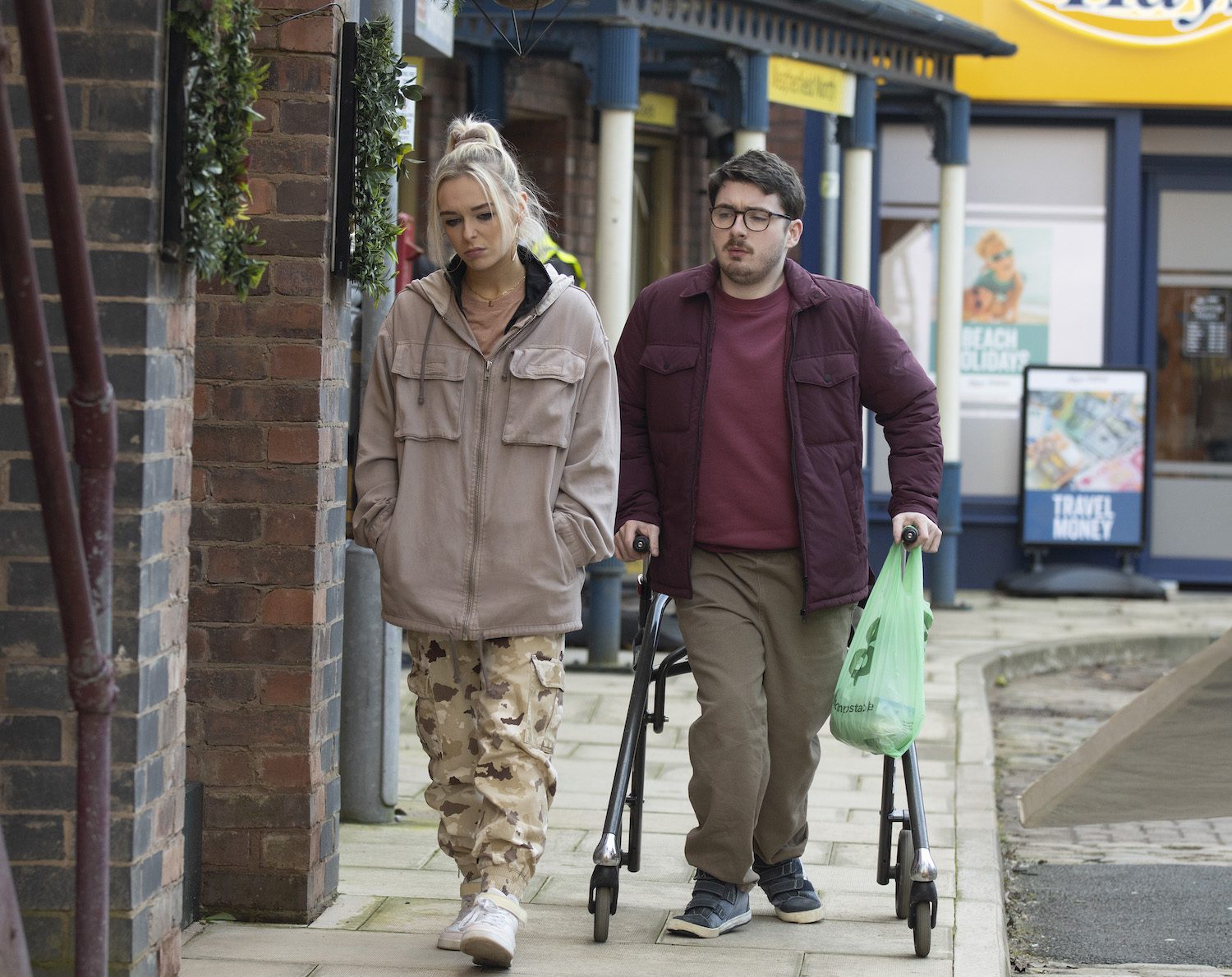 Lauren in Corrie looks fed up while Bobby tries to keep pace and help