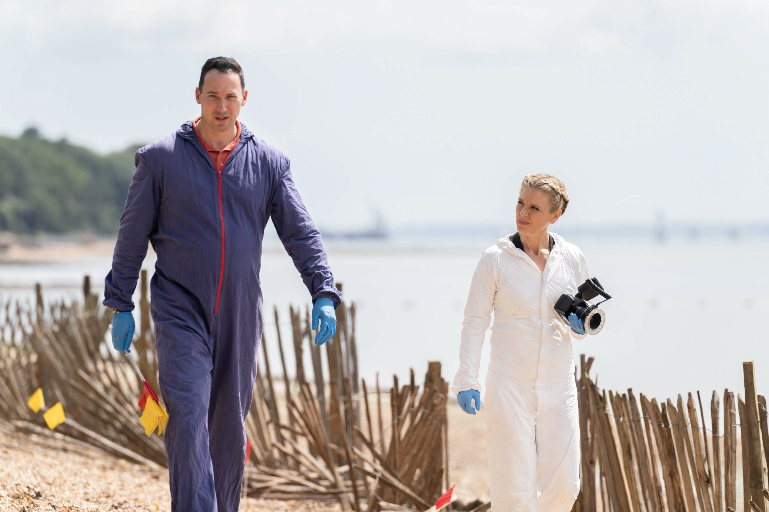Jack Hodgson (David Caves) and Dr Nikki Alexander (Emilia Fox) walking alongside the water to a murder scene