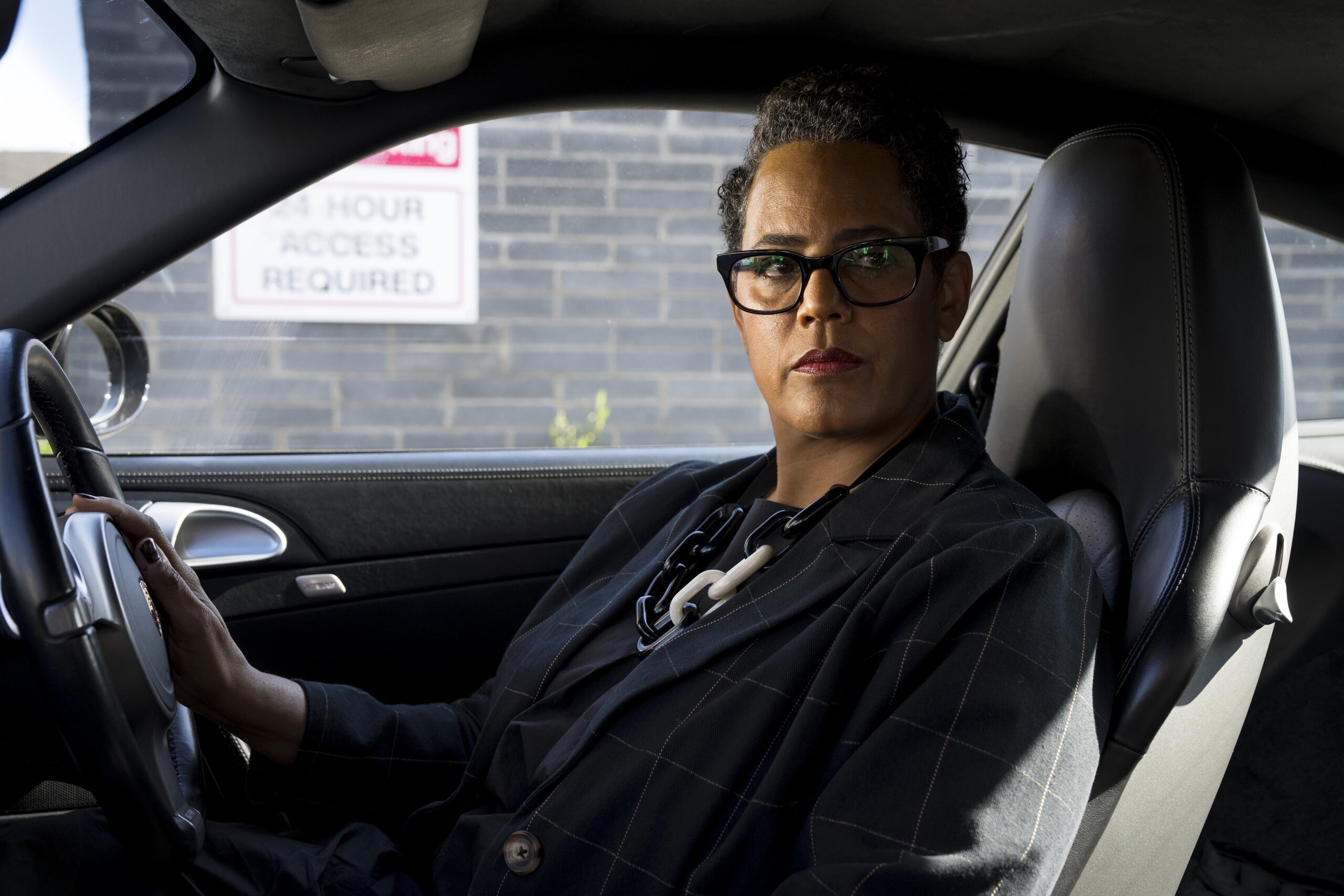 Sara Powell in a car looking to the camera as Simone in Too Good To Be True