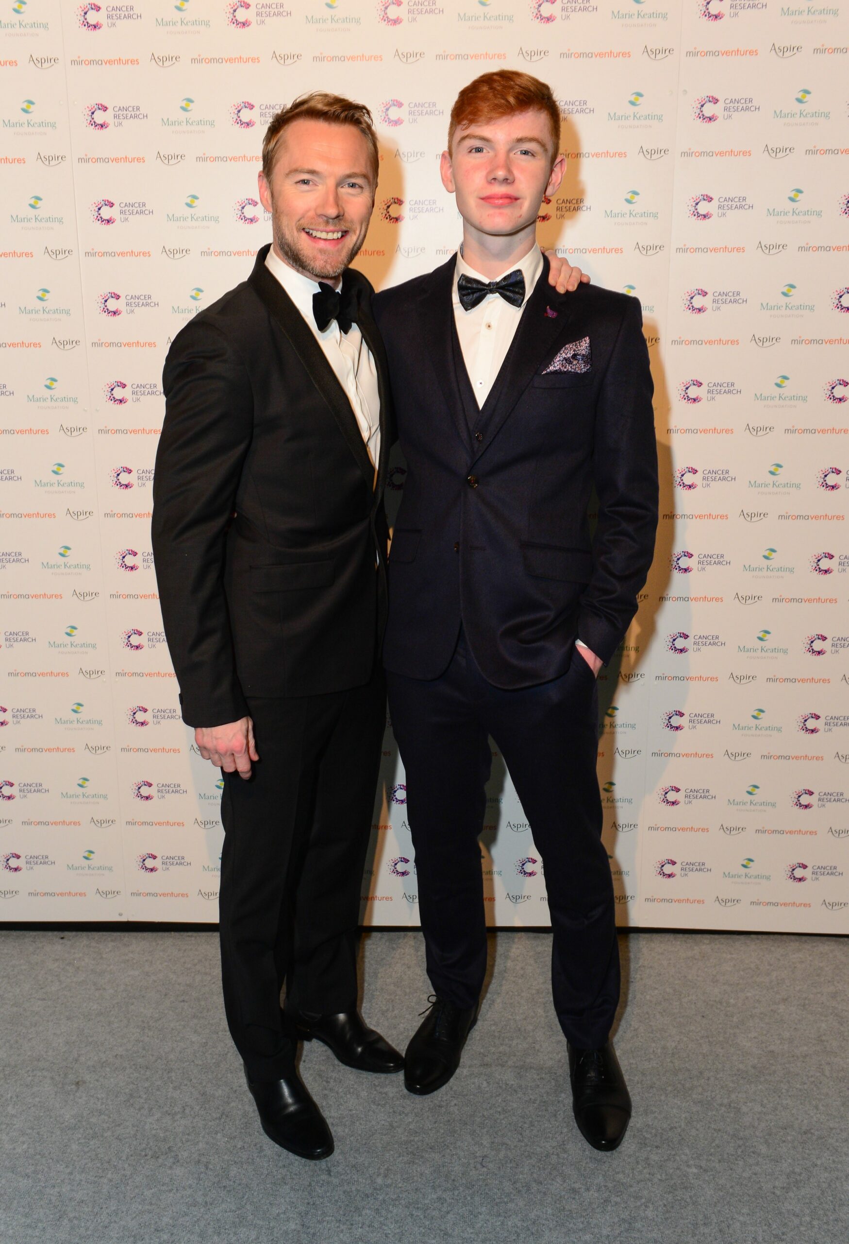 Ronan Keating smiling with son Jack at event