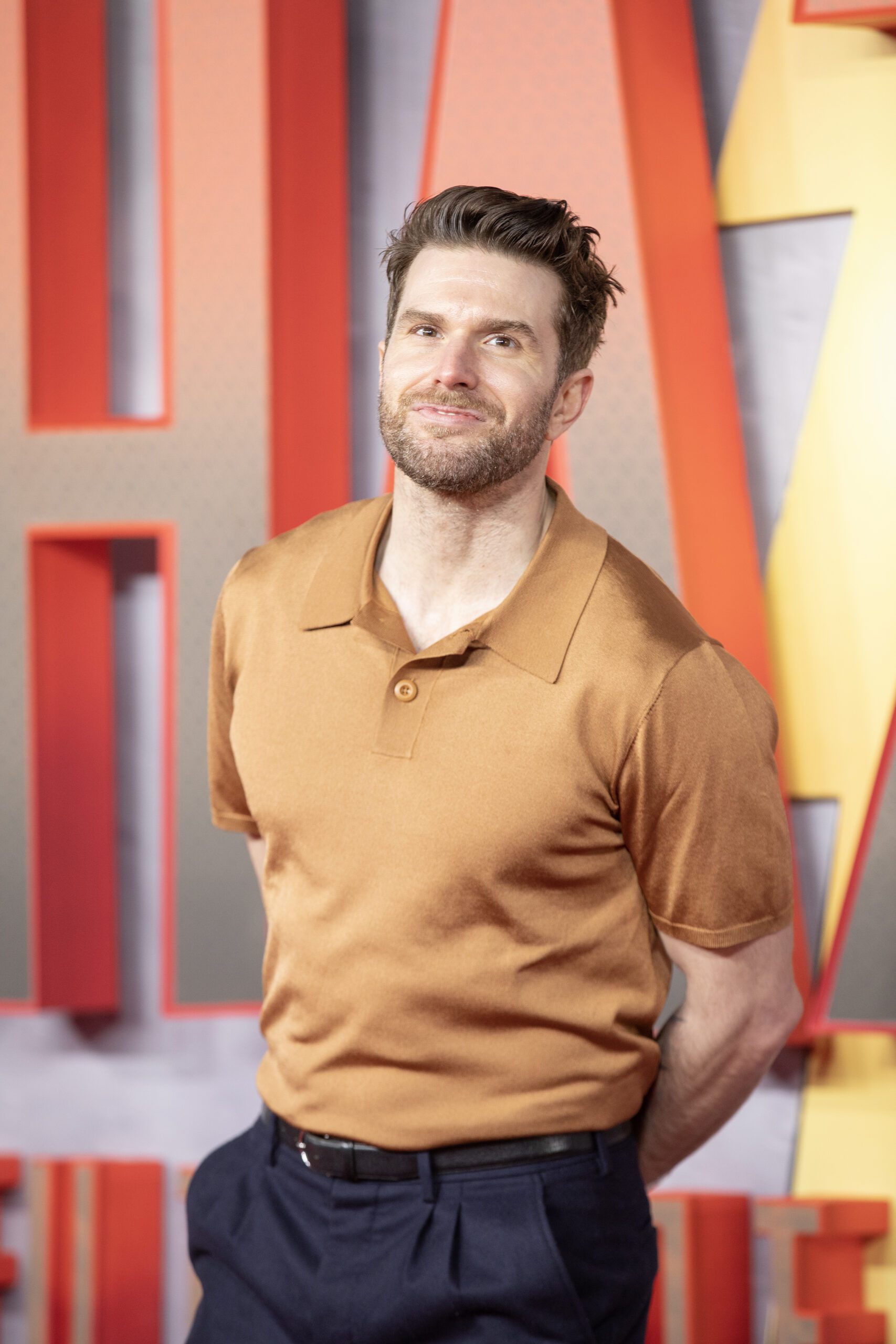 Joel Dommett smiling on the red carpet