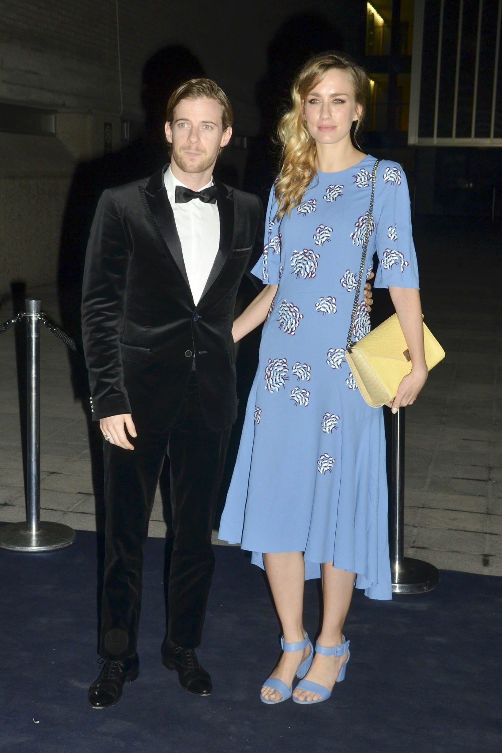 Luke Treadaway wearing a tuxedo and his wife Ruta Gedmintas wearing a blue dress as they posed together at the National Theatre fundraiser in 2015