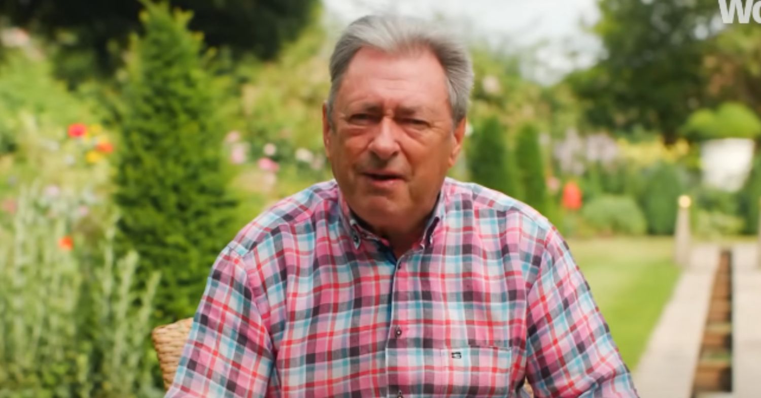 Alan Titchmarsh talking with a garden backdrop 