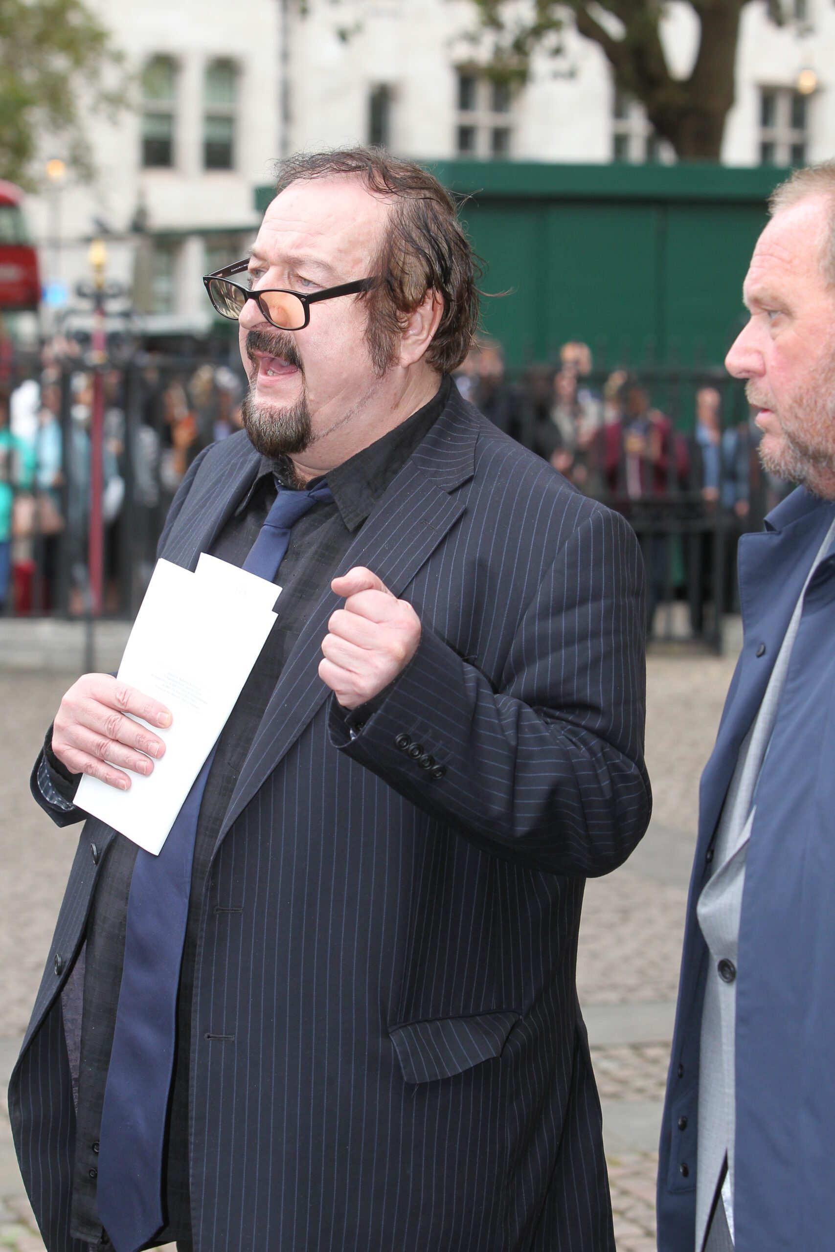 Steve Wright wearing a black suit